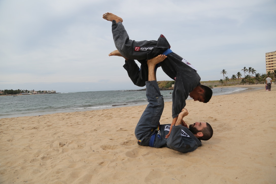 Malick and KOA teammate Anthony Garavalia perform Brazilian jiu jitsu techniques on Ngor Beach in Dakar, Senegal, on Nov. 2, 2013. 