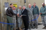 Air Force Lt. Gen. Sid Clarke, left, joins with officials from the Alabama National Guard in cutting the ribbon on the new Next Generation Data Acquisition Segment at the Alabama Air National Guard’s Eagle Vision 6 site at Redstone Arsenal, Ala. The new equipment allows for faster acquisition of unclassified satellite imagery to aid in the response to natural and manmade disasters as well as to provide worldwide support to contingency operations.