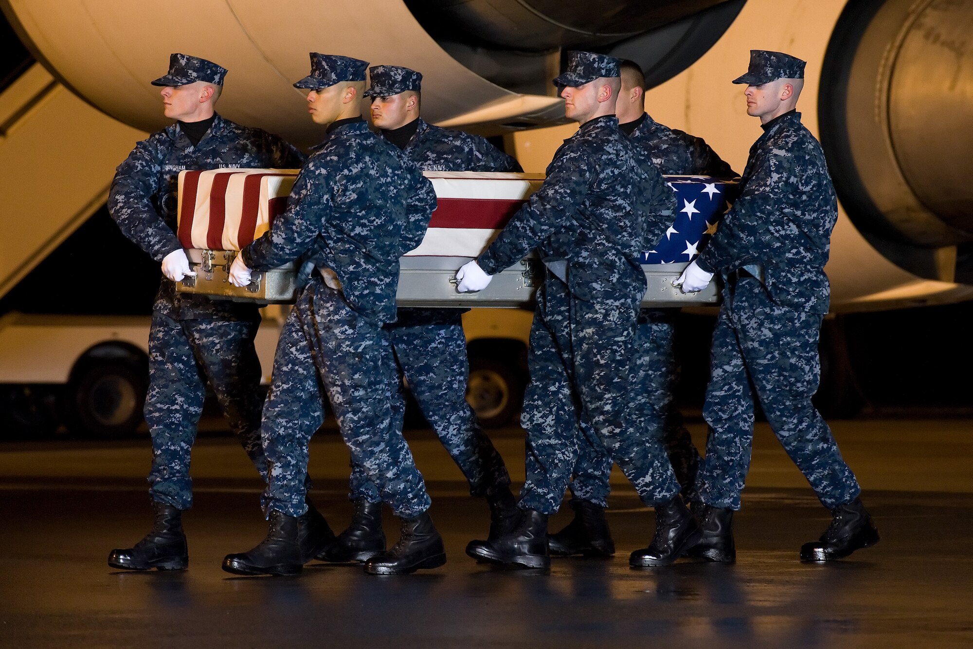 A U.S. Navy carry team transfers the remains of Department of the Navy civilian Philip H. Witherspoon, of Green Cove, Fla., at Dover Air Force Base, Del., Nov. 27, 2013. (U.S. Air Force photo/Roland Balik)