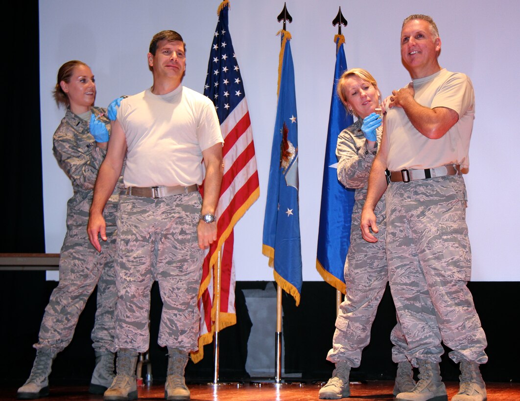 Fourth Air Force commander, Brig. Gen. John Flournoy, Jr., (smiling at right), and commander of the 932nd Airlift Wing, Col. Albert Lupenski (left), get their annual flu shots during a special surprise medical event at the November commander's call held during the unit training assembly. (U.S. Air Force photo / Meiko Schill)