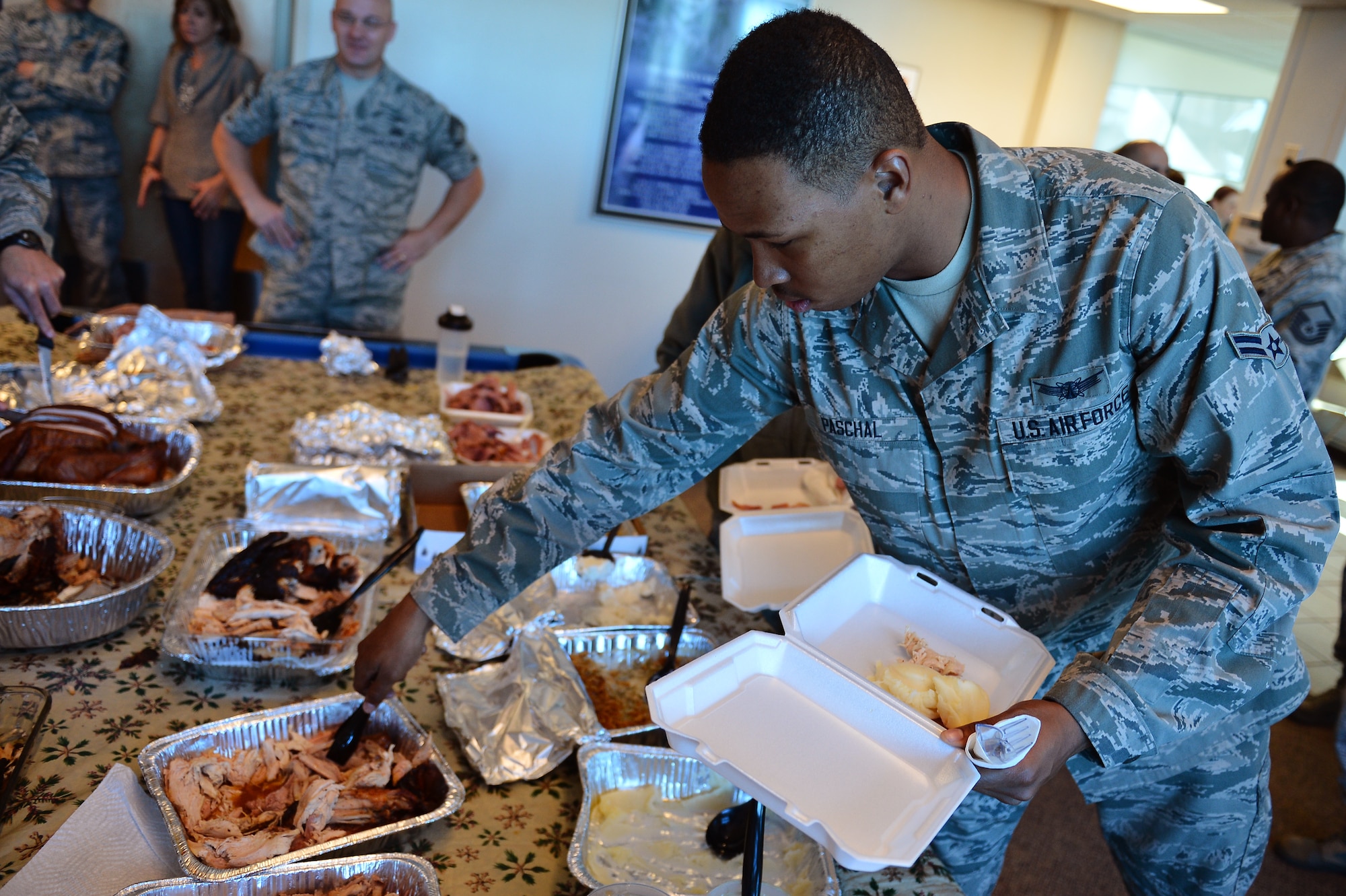 Airman 1st Class Justin Paschal, 2nd Space Warning Squadron, scores some turkey Nov. 27, 2013, at Patriot Hall on Buckley Air Force Base, Colo. Dorm residents were treated to a Thanksgiving dinner prepared and served by their senior leadership.  (U.S. Air Force photo by Senior Airman Riley Johnson/Released)
