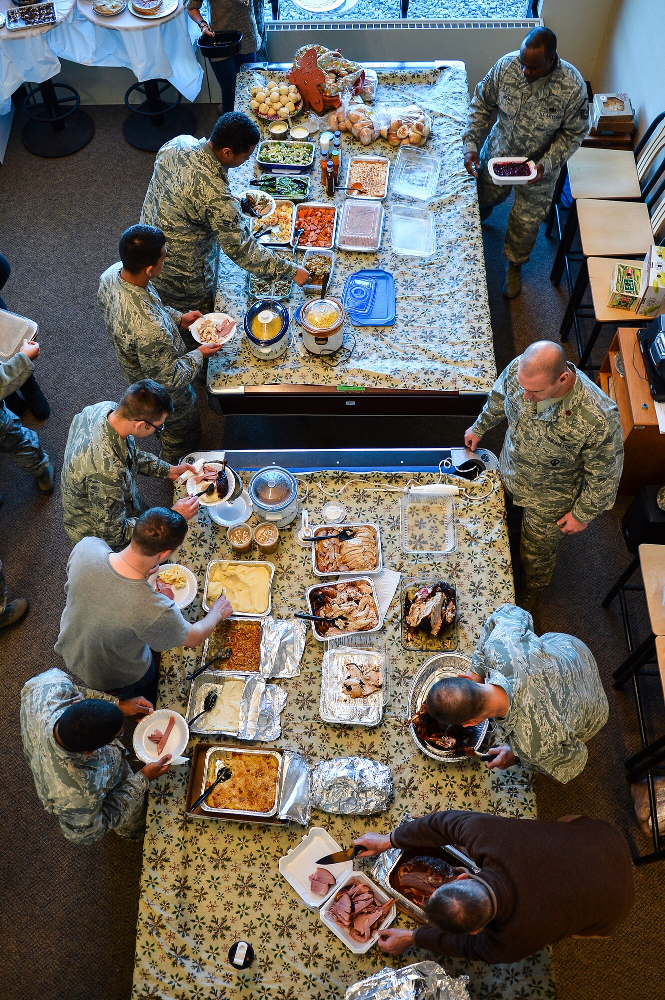 Patriot Hall dorm residents dish up food Nov. 27, 2013, at Patriot Hall on Buckley Air Force Base, Colo. Dorm residents were treated to a Thanksgiving dinner prepared and served by their senior leadership.  (U.S. Air Force photo by Senior Airman Riley Johnson/Released)