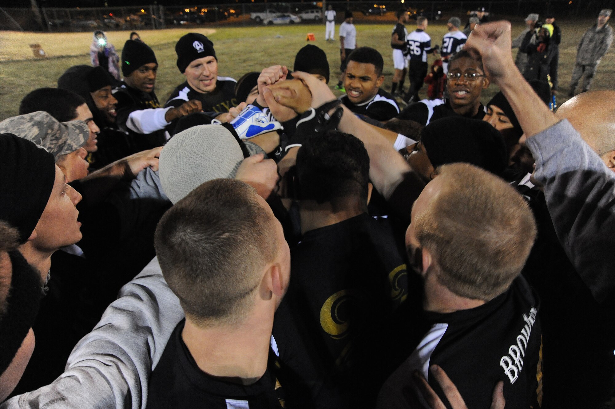 Members of the 509th Aircraft Maintenance Squadron Dragons intramural football team do a squadron chant before playing a championship game against the 509th Force Support Squadron at Whiteman Air Force Base, Mo., Nov. 15, 2013. The Dragons scored four touchdowns on the way to their fourth consecutive flag football championship. (U.S. Air Force photo by Staff Sgt. Nick Wilson/Released)
