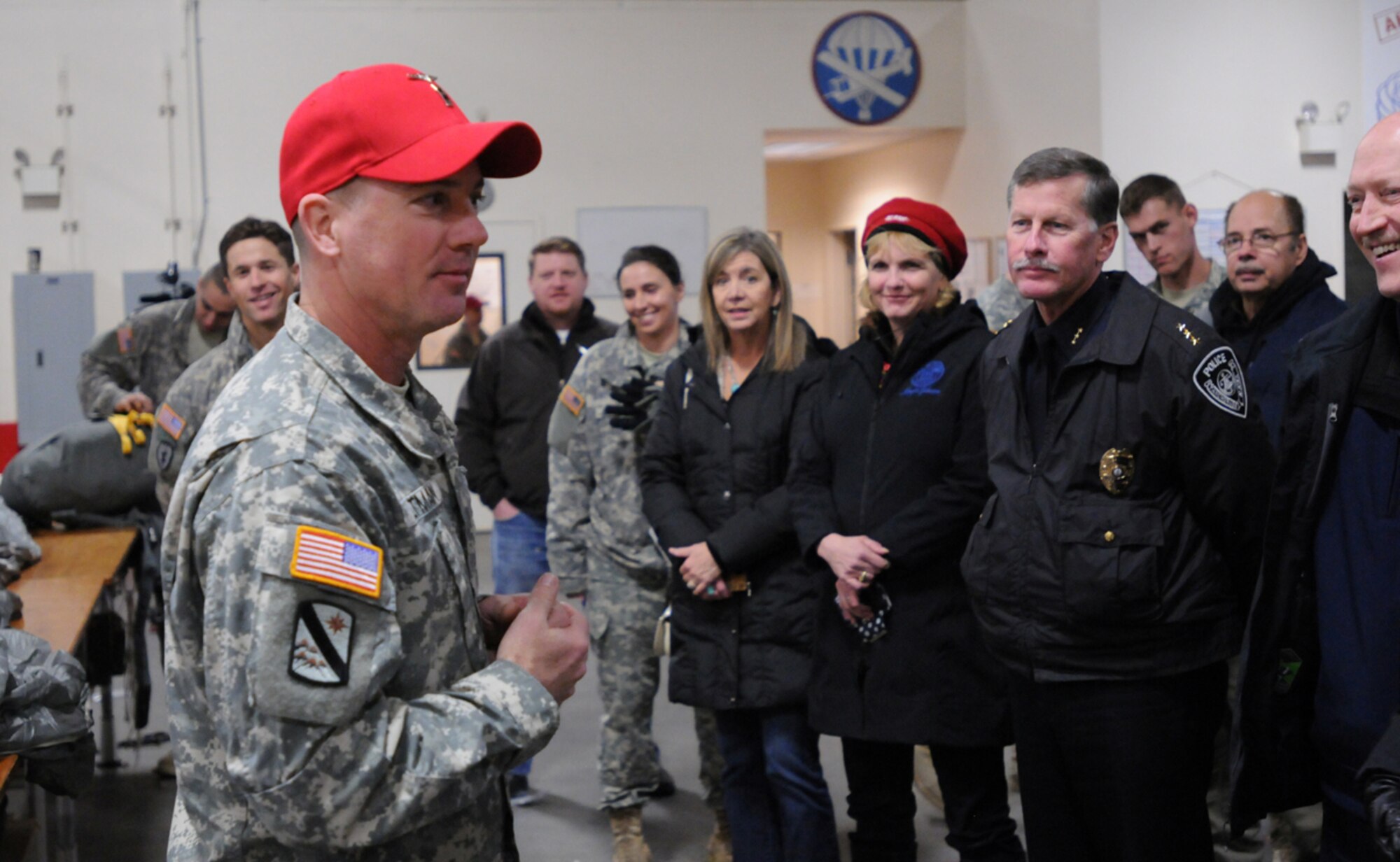 Chief Warrant Officer Christopher Altman, an airdrop technician with the 725th Brigade Support Battalion, 4th Infantry Brigade Combat Team (Airborne), 25th Infantry Division, gives a presentation on parachute rigging to a group of Alaska community leaders during “The Paratrooper Experience” community partnership day Nov. 13, at Joint Base Elmendorf-Richardson. Altman described the detailed, step-by-step, safety checks and procedures each parachute goes through before being approved for airborne operations. (U.S. Army photo/Staff Sgt. Jeffrey Smith)