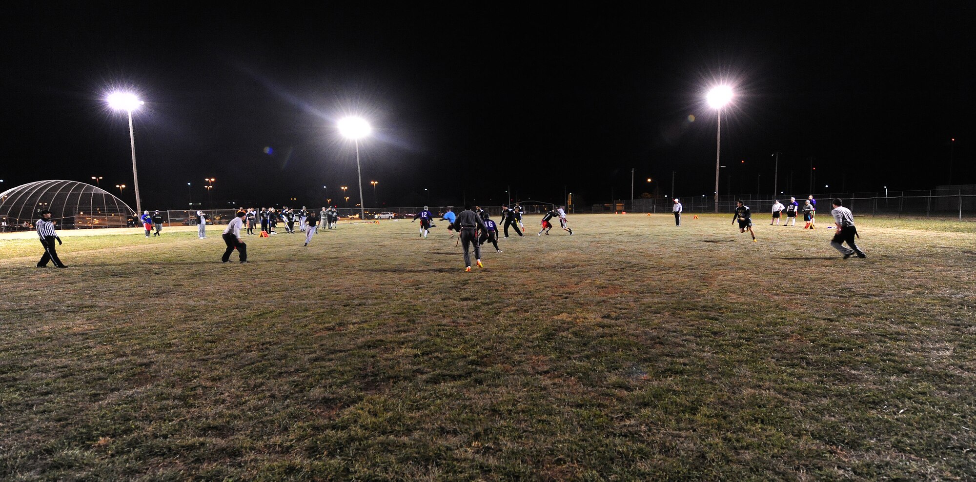 Intramural flag football players from the 509th Aircraft Maintenance Squadron Dragon team and the 509th Operations Support Squadron face off during a semifinal playoff game at Whiteman Air Force Base, Mo., Nov. 14, 2013. The Dragons were able to win the playoffs and the championship football game to become the only intramural team in Whiteman history to win four consecutive championship trophies. (U.S. Air Force photo by Staff Sgt. Nick Wilson/Released)