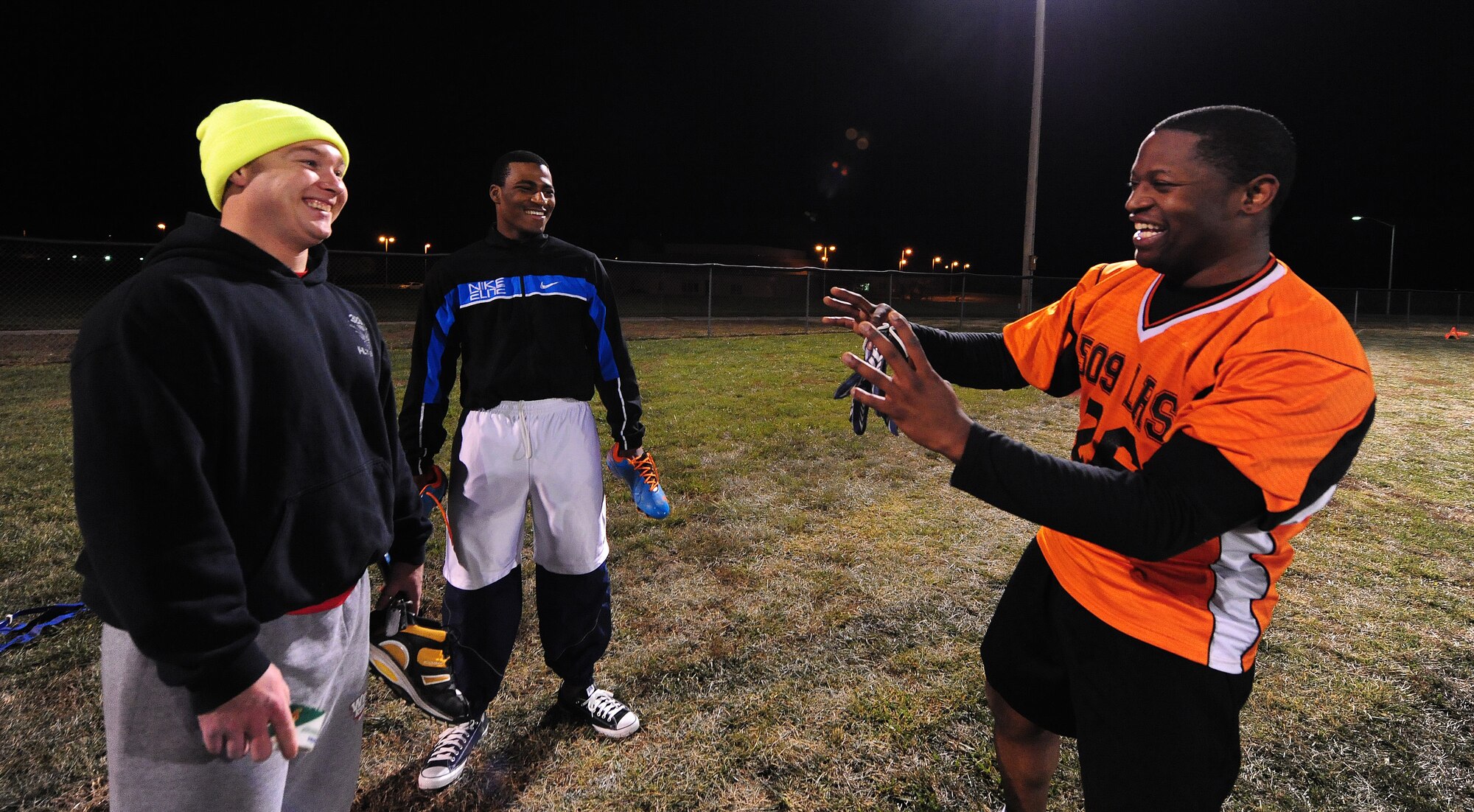 Christopher Neal, left, Curtis Hoston and Rashid Hill, all members of the 509th Logistics Readiness Squadron intramural flag football team, recount key catches and plays of their win against the the 709th Munitions Support Squadron after a semifinal playoff game at Whiteman Air Force Base, Mo.,  Nov. 14, 2013. The LRS team defeated the 709th Munitions Support Squadron 34-14 to advance to the final round of the playoffs. (U.S. Air Force photo by Staff Sgt. Nick Wilson/Released)
