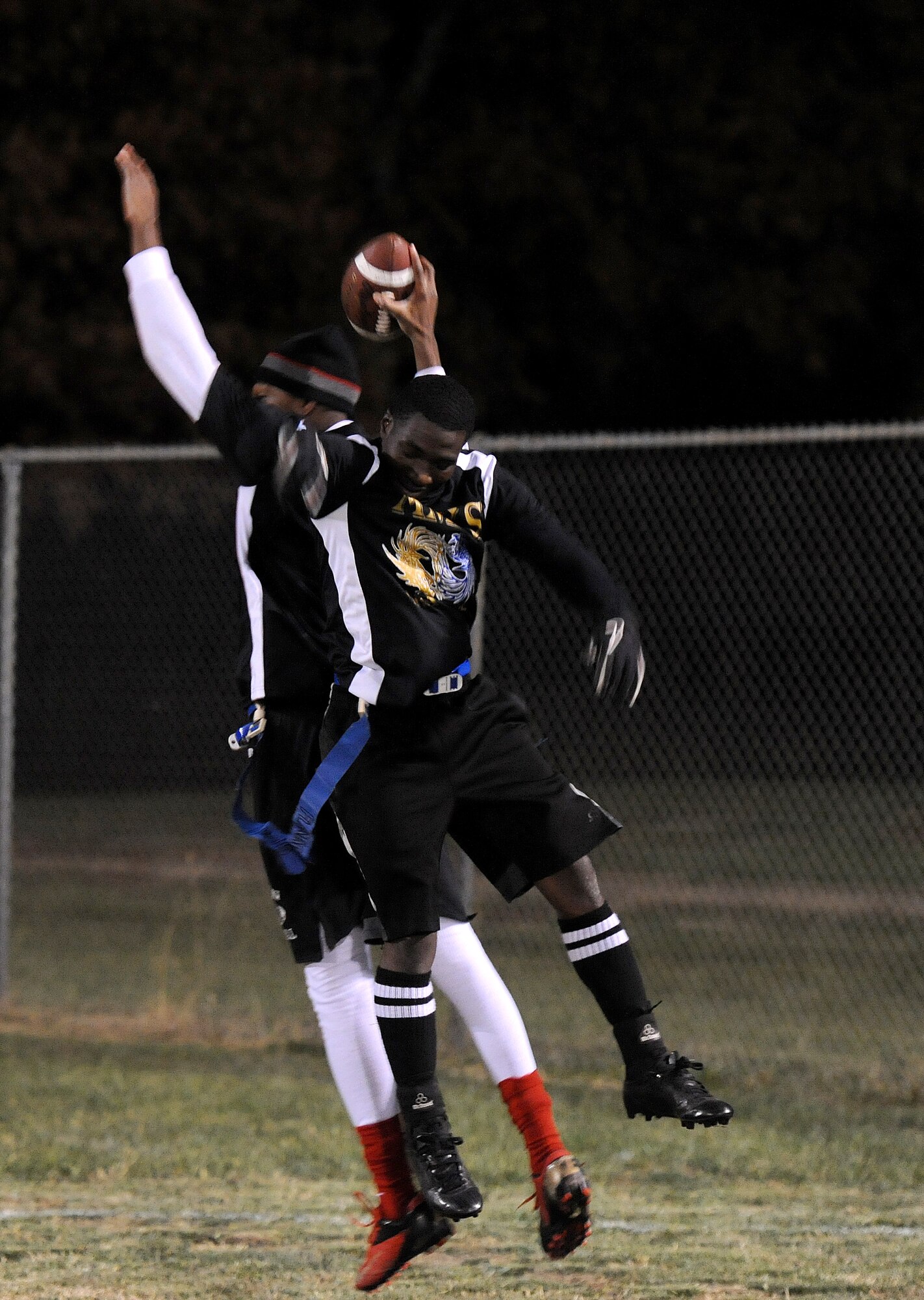Lester Jones and Elijah Fleming, members of the 509th Aircraft Maintenance Squadron Dragon flag football team, celebrate after scoring a touchdown during an intramural flag football playoff game against the Operations Support Squadron at Whiteman Air Force Base, Mo., Nov. 14, 2013. The Dragons won the playoffs and the flag football Super Bowl game to end the season with an undefeated record and finish off as champions for the fourth consecutive year. (U.S. Air Force photo by Staff Sgt. Nick Wilson/Released)