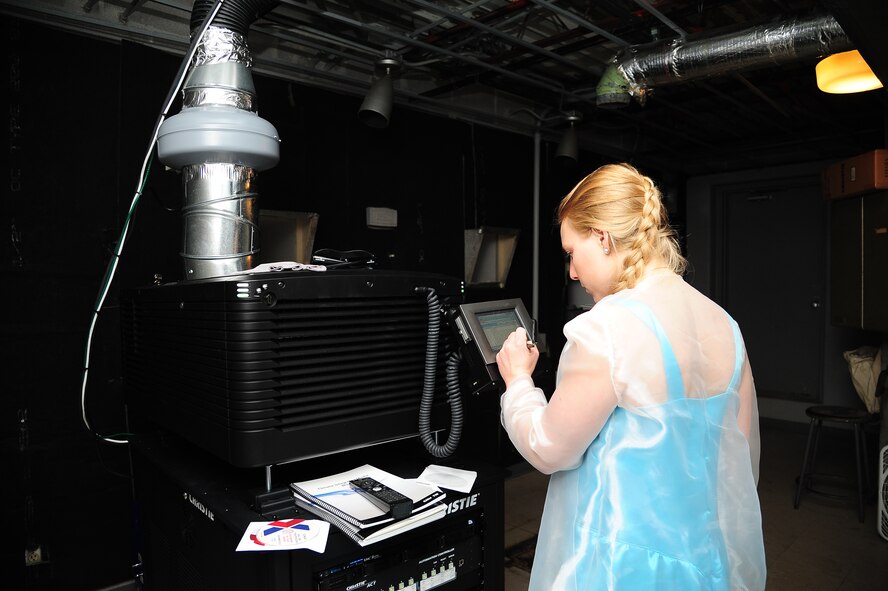 Sara Benson, Army and Air Force Exchange Service theater supervisor, loads “Frozen” onto the new digital projector during the Whiteman Theater grand re-opening Nov. 27, 2013, at Whiteman Air Force Base. The theater’s schedule can be accessed at www.shopmyexchange.com/ReelTimeTheatres/Movies-WhitemanAFB.htm or by calling 660-687-5110. (U.S. Air Force photo by Staff Sgt. Brigitte N. Brantley/Released)