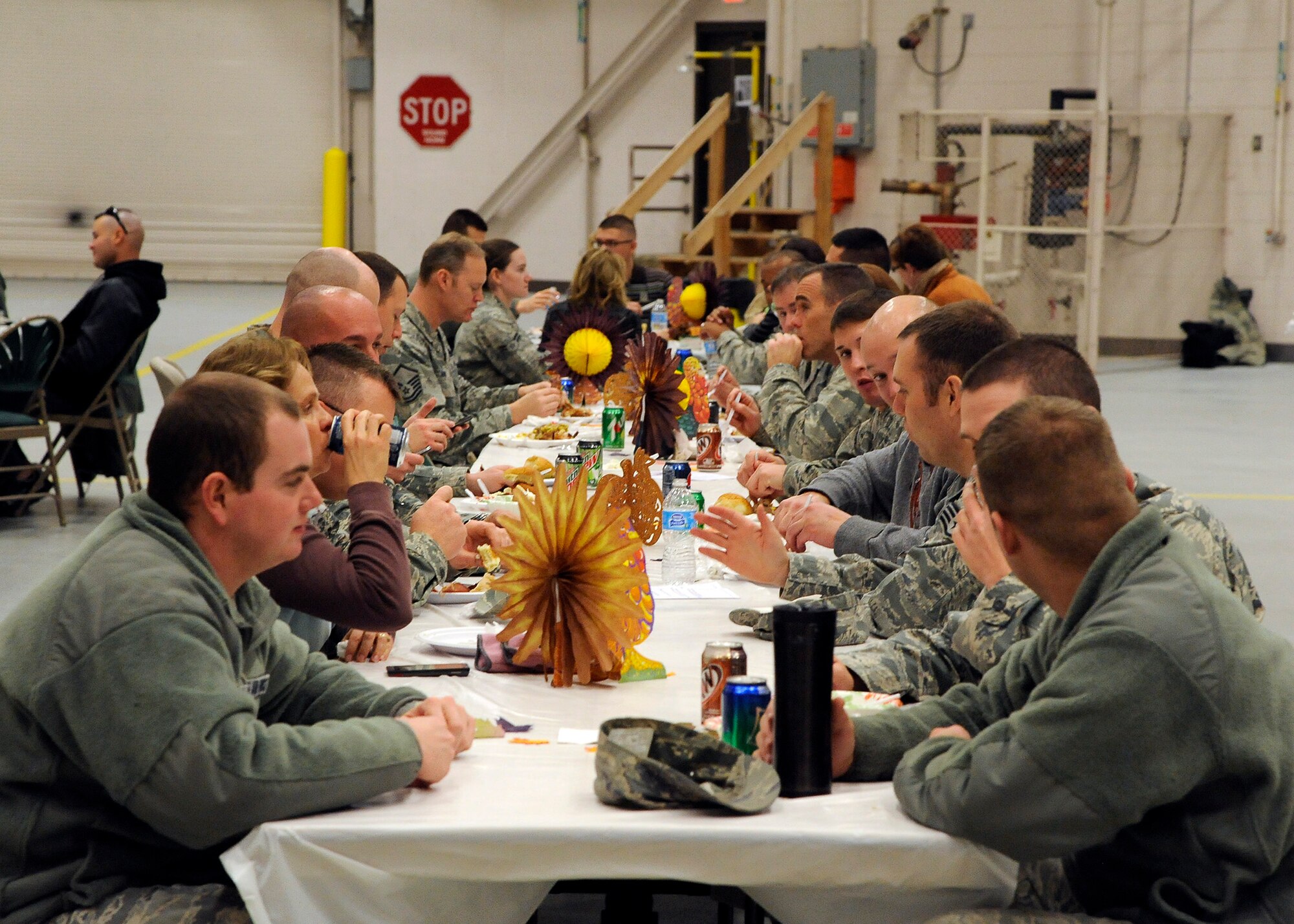Team Malmstrom members converse with one another during the 341st Maintenance Group’s annual Turkey Feed Nov. 22 at the 3-bay hangar. Attendees of the event had the chance to eat as much apple pie, turkey, cake, ham and cookies as possible and were offered more than 15 different entrees throughout the course of the meal. (U.S. Air Force photo/Airman 1st Class Collin Schmidt)