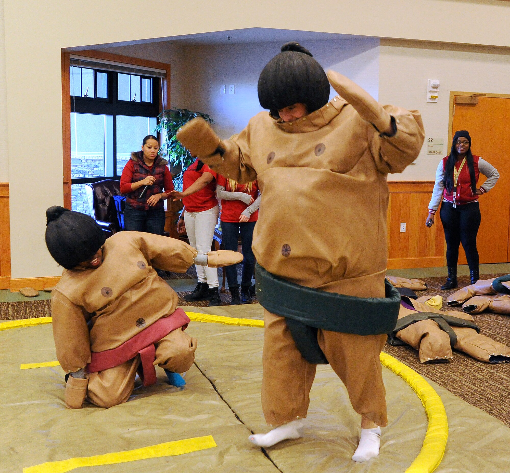 Senior Airman Joshua Busse, 341st Missile Security Forces Squadron member (right), does a victory dance after defeating Senior Airman Patricia Bachus, 341st MSFS member, in a game of sumo wrestling. Twelve events were offered during the Wing Sports Smackdown, ranging from flag football to basketball. (U.S. Air Force photo/Airman 1st Class Collin Schmidt)