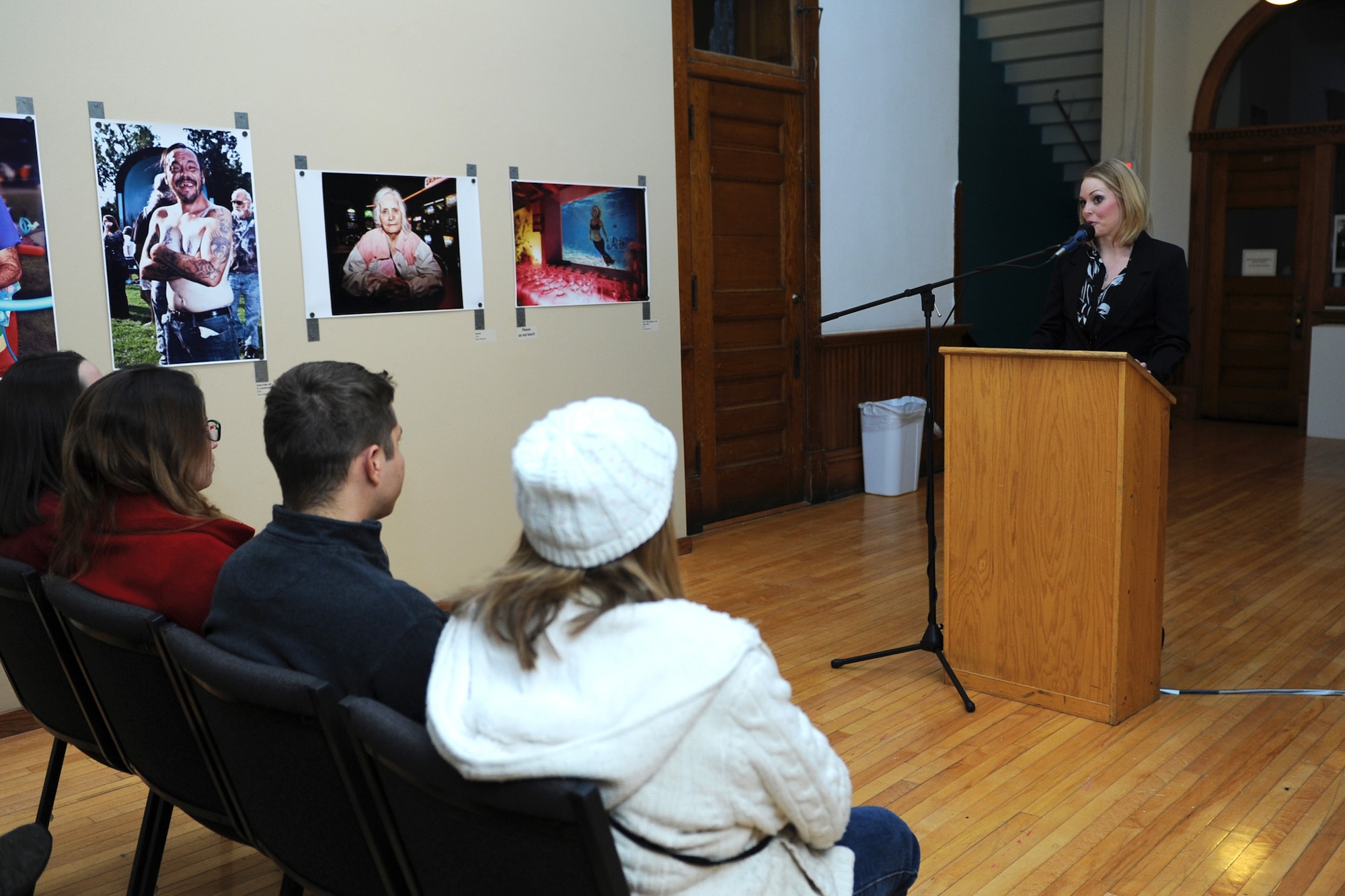 Senior Airman Alison Shildt, 341st Comptroller Squadron Defense Travel System lead technician, speaks to attendees during her photography exhibit opening at the Paris Gibson Square Museum of Art. Shildt’s creations consist of self-portraits, conceptual photography, and staged and non-staged surreal photography. (U.S. Air Force photo/Senior Airman Katrina Heikkinen)