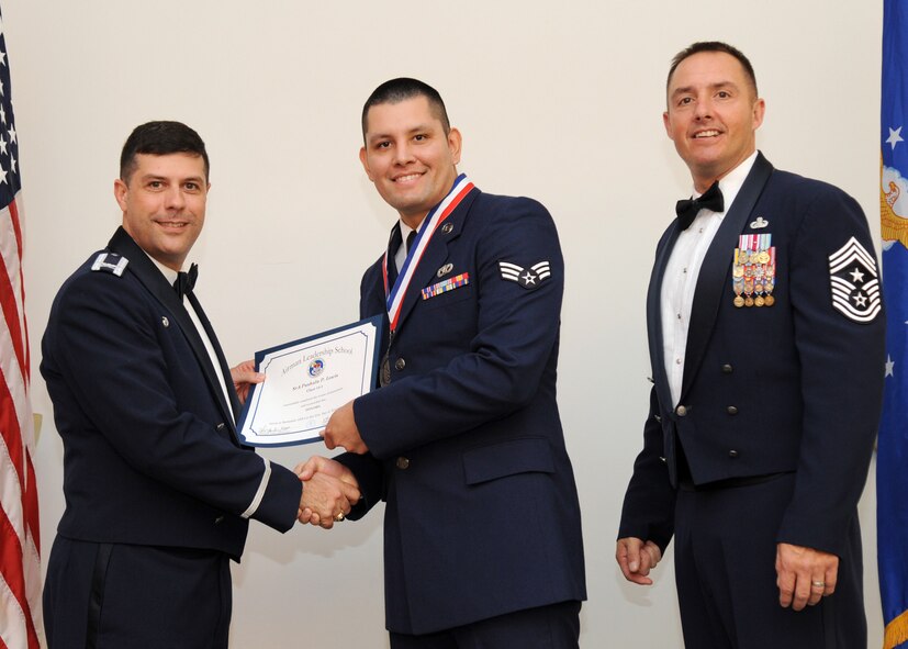 Senior Airman Pashala Lewis, 2nd Civil Engineer Squadron, receives an Airman Leadership School graduation certificate from Col. Andrew Gebara, 2nd Bomb Wing commander, on Barksdale Air Force Base, La., Nov. 21, 2013. (U.S. Air Force photo/Senior Airman Joseph A. Pagán Jr.)