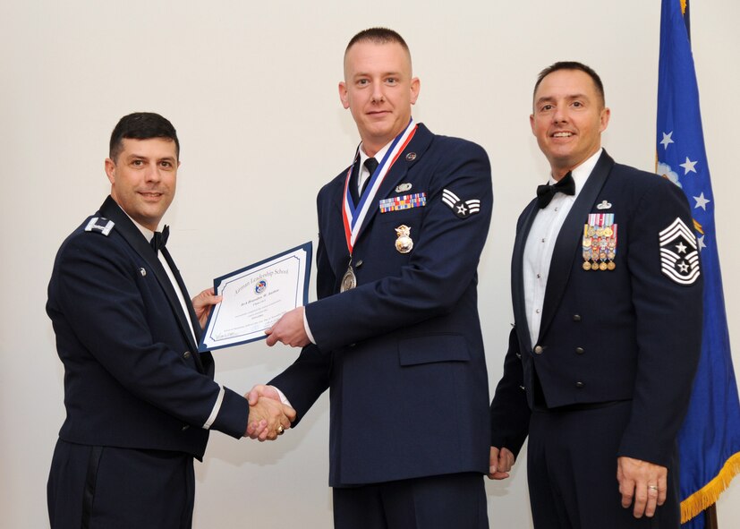 Senior Airman Brandon Anthis, 2nd Security Forces Squadron, receives an Airman Leadership School graduation certificate from Col. Andrew Gebara, 2nd Bomb Wing commander, on Barksdale Air Force Base, La., Nov. 21, 2013. (U.S. Air Force photo/Senior Airman Joseph A. Pagán Jr.)