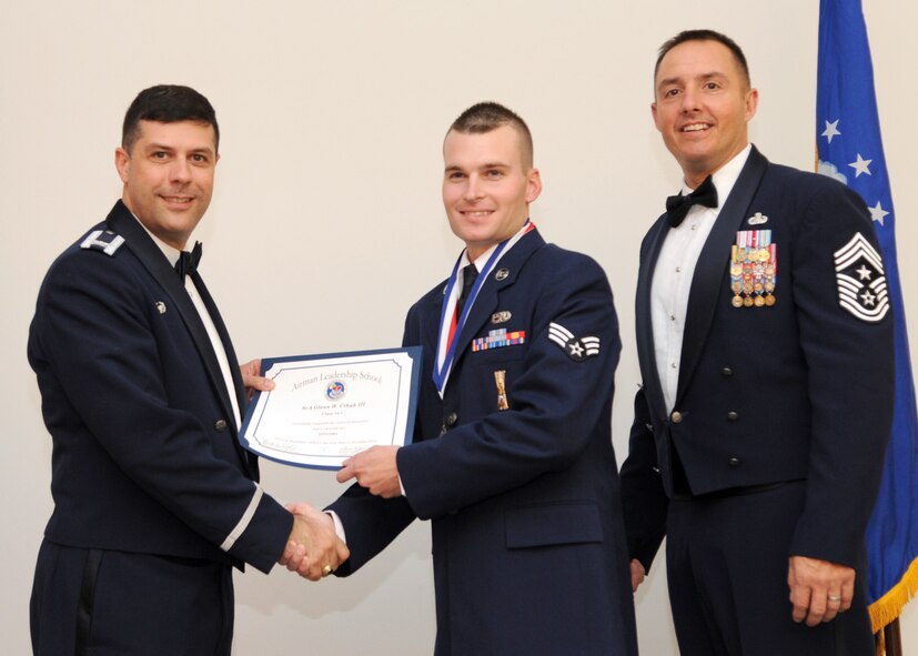 Senior Airman Glenn Cihak III, 2nd Aircraft Maintenance Squadron, receives an Airman Leadership School graduation certificate from Col. Andrew Gebara, 2nd Bomb Wing commander, on Barksdale Air Force Base, La., Nov. 21, 2013. (U.S. Air Force photo/Senior Airman Joseph A. Pagán Jr.)
