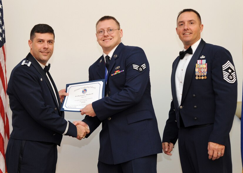 Senior Airman Raymond Whatley, 608th Air and Space Operations Squadron, receives an Airman Leadership School graduation certificate from Col. Andrew Gebara, 2nd Bomb Wing commander, on Barksdale Air Force Base, La., Nov. 21, 2013. (U.S. Air Force photo/Senior Airman Joseph A. Pagán Jr.)