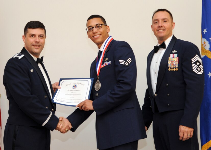 Senior Airman Robert Chesebro, 2nd Communications Squadron, receives an Airman Leadership School graduation certificate from Col. Andrew Gebara, 2nd Bomb Wing commander, on Barksdale Air Force Base, La., Nov. 21, 2013. (U.S. Air Force photo/Senior Airman Joseph A. Pagán Jr.)