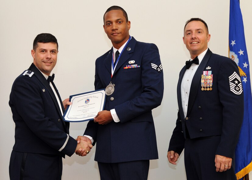 Senior Airman Jeffery Hairston Jr., 2nd Contracting Squadron, receives an Airman Leadership School graduation certificate from Col. Andrew Gebara, 2nd Bomb Wing commander, on Barksdale Air Force Base, La., Nov. 21, 2013. (U.S. Air Force photo/Senior Airman Joseph A. Pagán Jr.)
