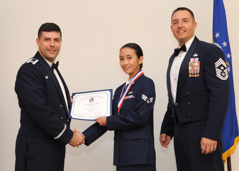 Senior Airman Tonirose Chow, 2nd Logistics Readiness Squadron, receives an Airman Leadership School graduation certificate from Col. Andrew Gebara, 2nd Bomb Wing commander, on Barksdale Air Force Base, La., Nov. 21, 2013. (U.S. Air Force photo/Senior Airman Joseph A. Pagán Jr.)