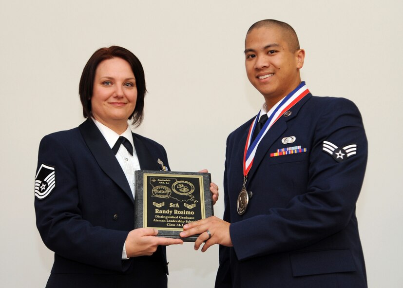 Senior Airman Randy Rosimo, 26th Operational Weather Squadron, receives the Distinguished Graduate Award from Tech. Sgt. Joelle Silny, Air Force Global Strike Command, on behalf of the Air Force Sergeants Association during the Airman Leadership School Class 14-1 Graduation on Barksdale Air Force Base, La., Nov. 21, 2013. (U.S. Air Force photo/Senior Airman Joseph A. Pagán Jr.)