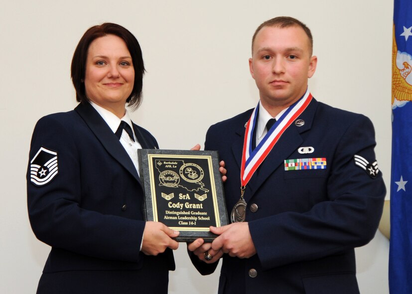 Senior Airman Cody Grant, 26th Operational Weather Squadron, receives the Distinguished Graduate Award from Tech. Sgt. Joelle Silny, Air Force Global Strike Command, on behalf of the Air Force Sergeants Association during the Airman Leadership School Class 14-1 Graduation on Barksdale Air Force Base, La., Nov. 21, 2013. (U.S. Air Force photo/Senior Airman Joseph A. Pagán Jr.)