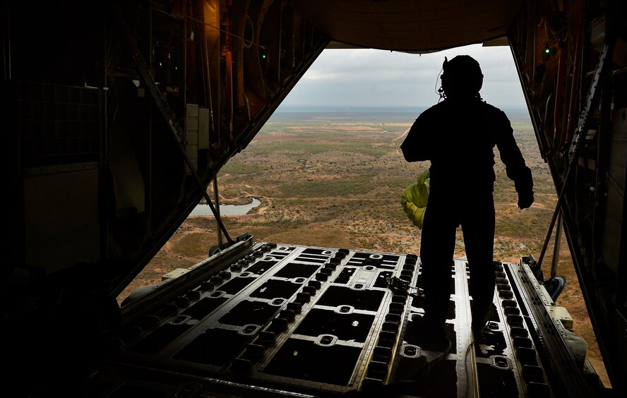 U.S. Air Force Senior Airman Matthew Bihlajama, 40th Airlift Squadron loadmaster, releases cargo from a C-130J Super Hercules at a drop zone Nov. 21, 2013, during Impact Day near Bronte, Texas. Impact Day gave maintainers from the 317th Airlift Group the opportunity to fly aboard a C-130J as it dropped cargo bundles at a designated drop zone. (U.S. Air Force photo by Staff Sgt. Vernon Young Jr./Released)