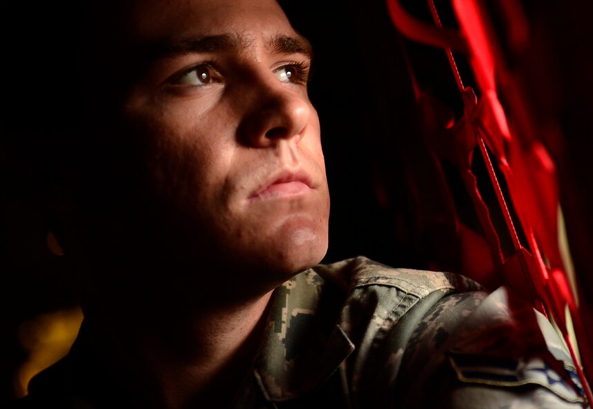 U.S. Air Force Airman 1st Class Kyle Eccles, 317th Aircraft Maintenance Squadron crew chief, looks out the side window of a C-130J Super Hercules Nov. 21, 2013, during Impact Day at Dyess Air Force Base, Texas. Impact Day gave aircraft maintainers a chance to shadow aircrew personnel as they conducted an airdrop resupply training mission. (U.S. Air Force photo by Staff Sgt. Vernon Young Jr./Released)