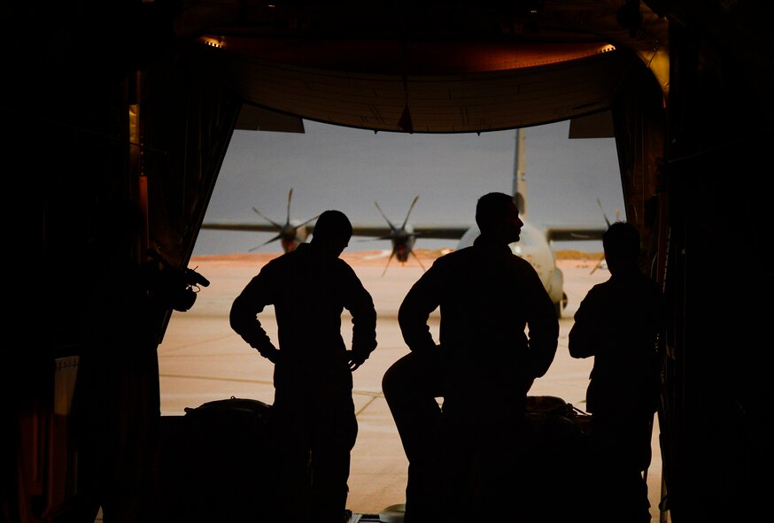 Aircrew and maintenance personnel assemble for a mission brief on a C-130J Super Hercules Nov. 21, 2013, during Impact Day at Dyess Air Force Base, Texas. Maintainers from the 317th Airlift Group had the opportunity to learn what the aircrew members go through during an airdrop resupply mission. (U.S. Air Force photo by Staff Sgt. Vernon Young Jr./Released)