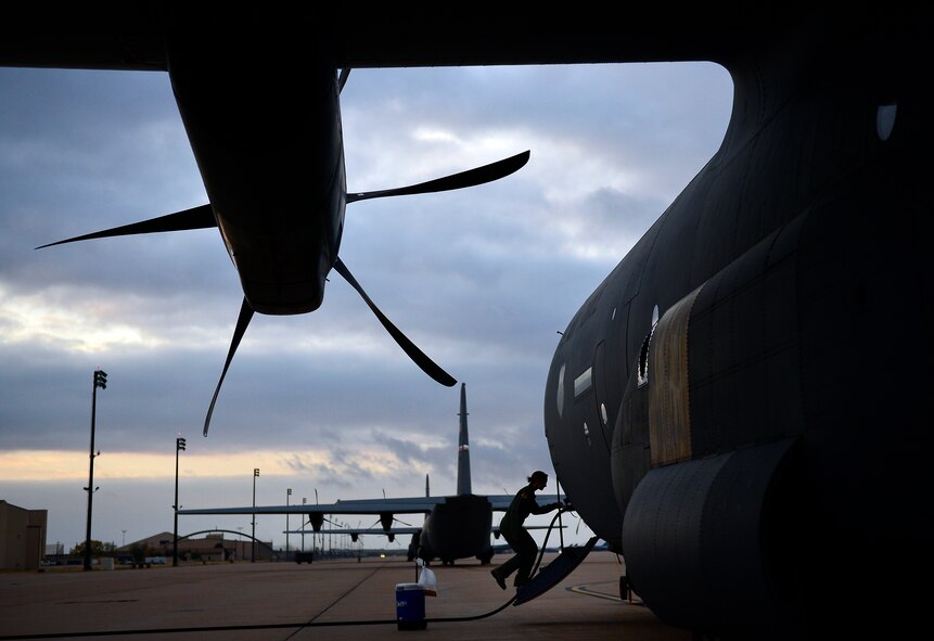U.S. Air Force Capt. Heather Lendrum, 39th Airlift Squadron, enters a C-130J  Nov. 21, 2013, during Impact Day at Dyess Air Force Base, Texas. Impact Day was an opportunity for maintainers and aircrew personnel  to observe each other’s role in the Air Force. This training exercise allowed maintainers the opportunity to fly along with the crew as they dropped cargo bundles from a C-130J. (U.S. Air Force photo by Staff Sgt. Vernon Young Jr./Released)