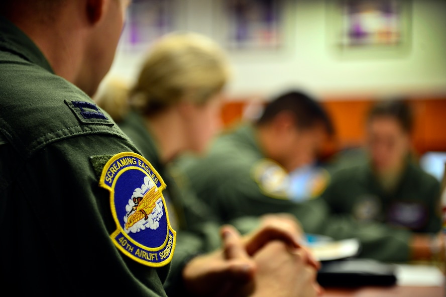 U.S. Air Force C-130J Super Hercules aircrew personnel assigned to the 40th Airlift Squadron, discuss mission plans Nov. 21, 2013, during Impact Day at Dyess Air Force Base, Texas. Impact Day was an opportunity for maintainers and aircrew personnel to understand the roles each play in the Air Force. Pre-mission briefs such as this, allow all members of the crew to come together prior to the flight and discuss how the mission is going to play out, so that it is executed correctly and safely. (U.S. Air Force photo by Staff Sgt. Vernon Young Jr./Released)