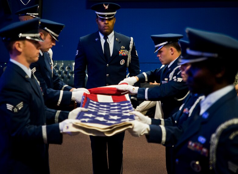 Staff Sgt. William Anderson, 901st Special Operations Aircraft Maintenance Squadron propulsion craftsman, stands at attention as a flag is folded at a funeral service Jan. 13, 2013, at Duke Field, Fla. Anderson returned to his career field in September 2013, after almost three years as NCO in charge of the Eglin Air Force Base honor guard. (U.S. Air Force photo/Tech Sgt. Samuel King Jr.)