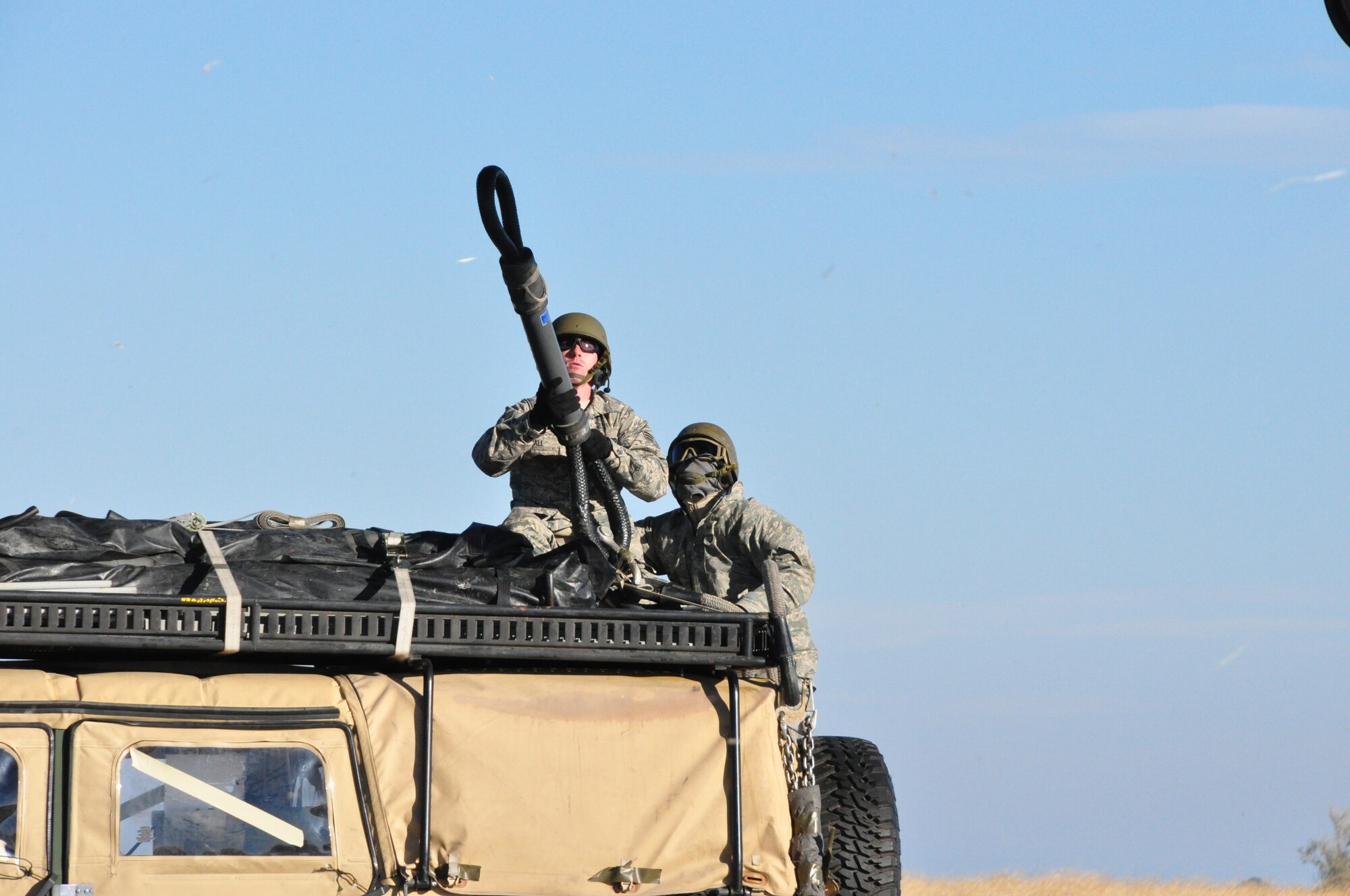 Airmen from 60th Aerial Port Squadron prepare to connect the sling on a humvee to a CH-47 Chinook Nov. 21 on an airfield in Rio Vista. (U.S. Air Force photo/Staff Sgt. Patrick Harrower)