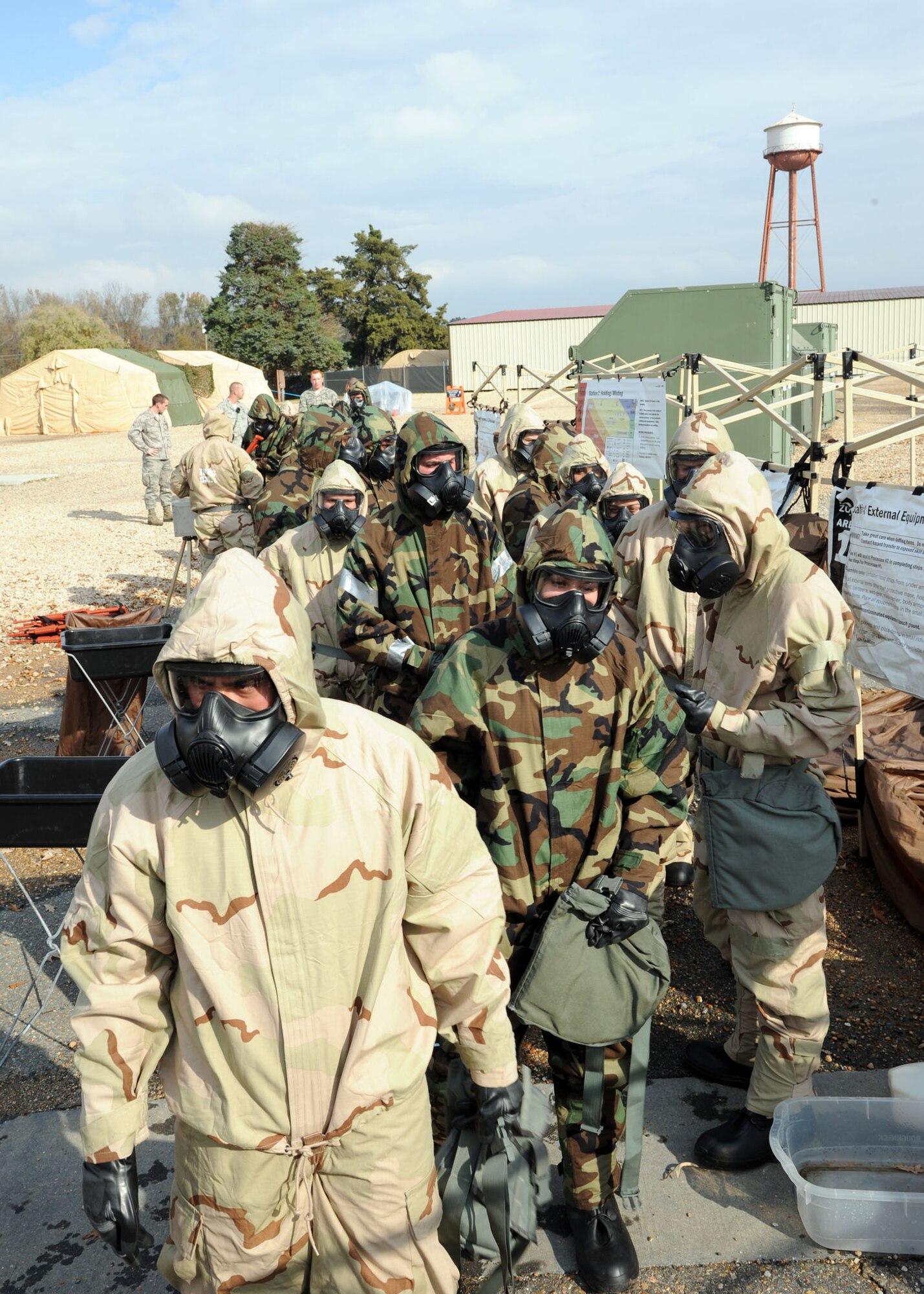 Airmen walk through a contamination control area during an Ability to Survive and Operate scenario on Barksdale Air Force Base, La., Nov. 21, 2013. The CCA was used to accomplish technical decontamination during the ATSO. (U.S. Air Force photo/Senior Airman Joseph A. Pagán Jr.)