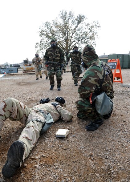 Senior Airman Sean Martin, 2nd Bomb Wing Public Affairs, lies on the ground during at Ability to Survive and Operate scenario on Barksdale Air Force Base, La., Nov. 21, 2013.  Martin laid on the ground to simulate being a chemical casualty to see how well other Airmen responded to the emergency during the ATSO scenario. (U.S. Air Force photo/Senior Airman Joseph A. Pagán Jr.)