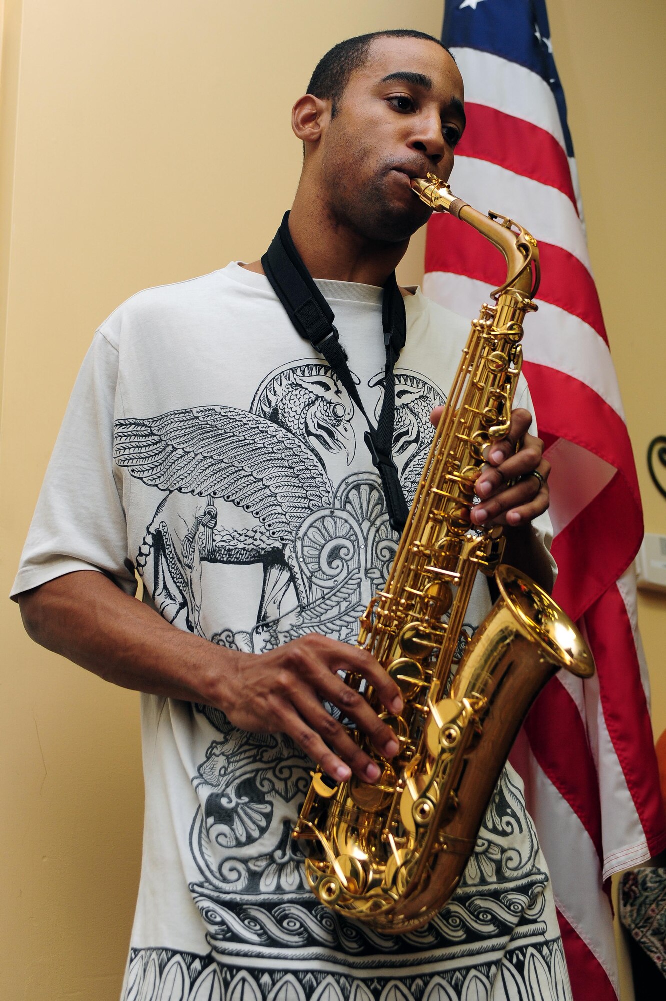 U.S. Air Force Airman 1st Class Daniel Blackwell, 4th Fighter Wing public affairs photojournalist, plays the saxophone at the Community Soup Kitchen in Goldsboro, N.C., Nov. 27, 2013.  Blackwell played music to foster a more festive atmosphere while multiple members of the 4th Fighter Wing served meals to more than 100 hungry members of the local community. (U.S. Air Force photo by Airman 1st Class John Nieves Camacho)