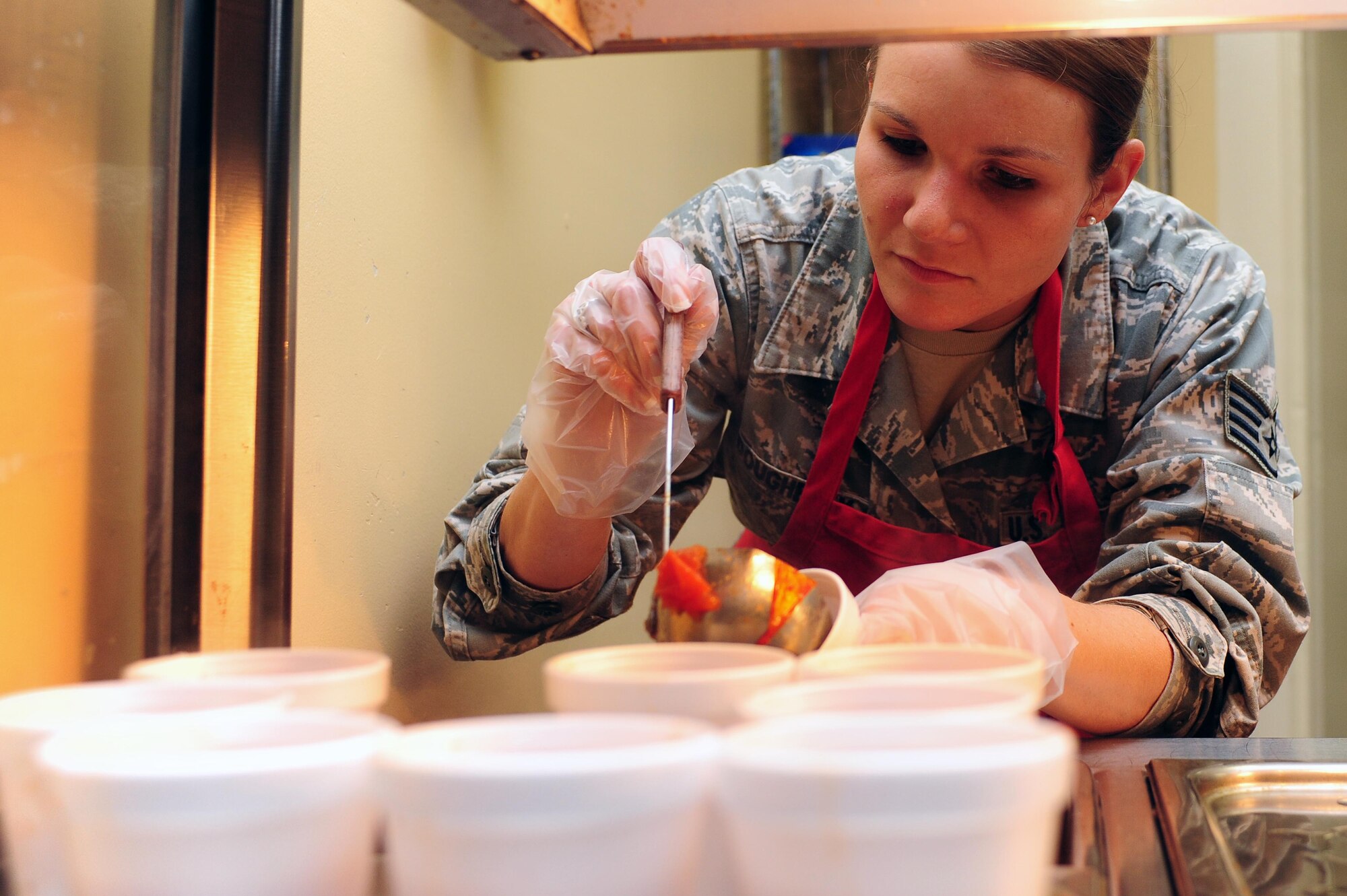 U.S. Air Force Staff Sgt. Samantha Dougherty, executive assistant to the 4th Fighter Wing command chief, serves food at the Community Soup Kitchen in Goldsboro, N.C., Nov. 27, 2013. The mission of the soup kitchen is to provide a daily meal for those who are hungry. (U.S. Air Force photo by Airman 1st Class John Nieves Camacho)