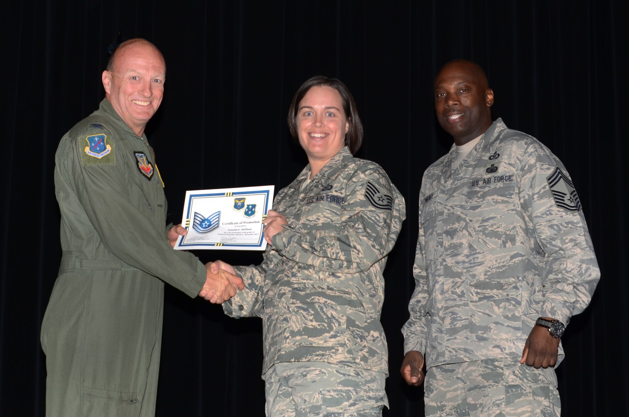 Staff Sgt. Amanda Hoffman, 612th Air and Space Operations Center, receives a certificate from Col. Bruce Smith, 12th Air Force (Air Forces Southern) vice commander, congratulating her on her promotion to technical sergeant at the base theater on Davis-Monthan AFB, Ariz., Nov. 27, 2013.  Hoffman’s promotion will go into effect on Dec. 1. (U.S. Air Force photo by Staff Sgt. Heather R. Redman/Released)