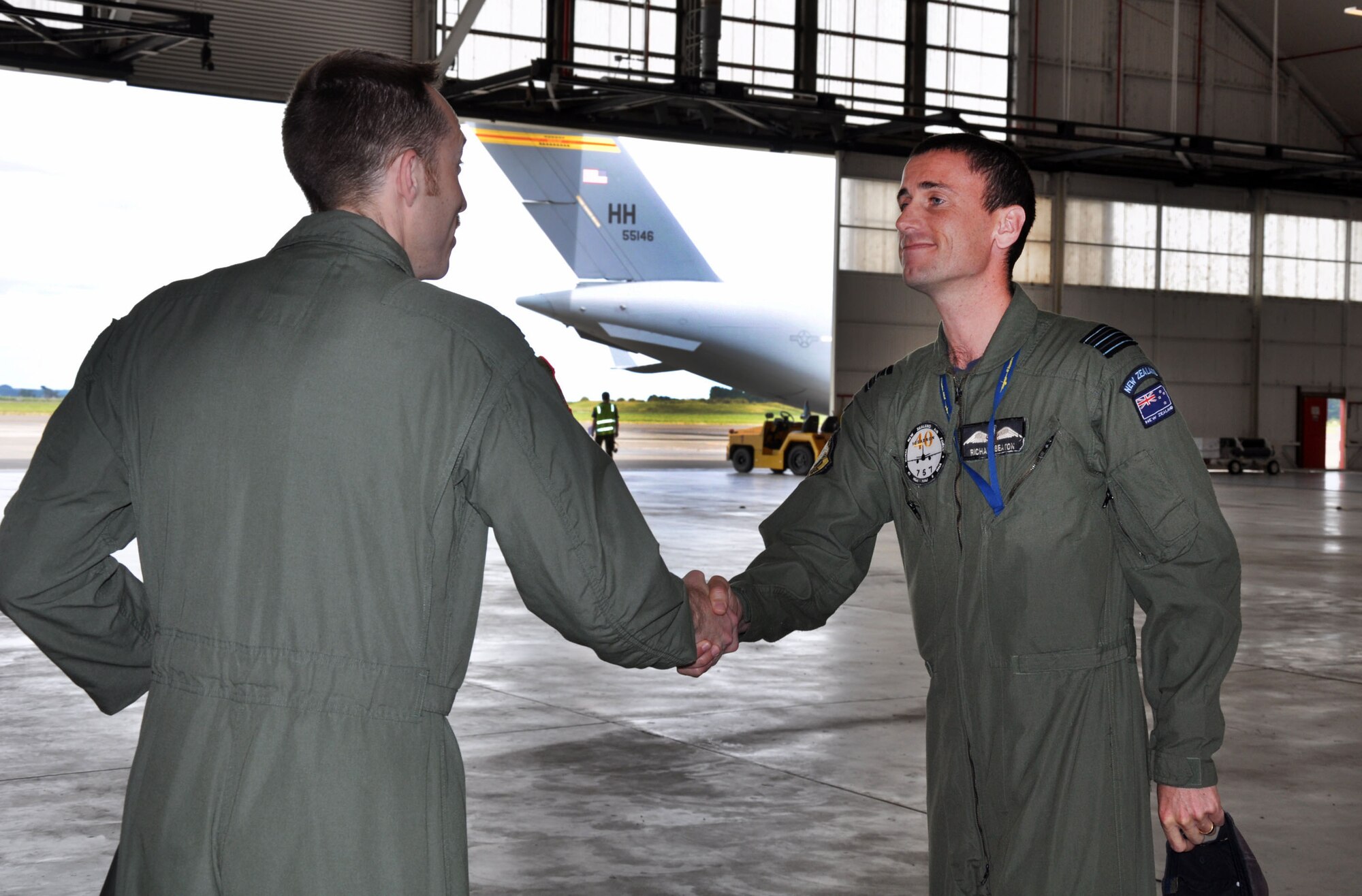 Wing Commander Richard Beaton (left), Royal New Zealand Air Force Base Ohakea, bids farewell to United States Air Force Lt. Col. Phillip Shea, 517th Expeditionary Airlift Squadron commander, as he prepares to depart the RNZAF base in New Zealand Nov. 25. More than 70 U.S. Airmen from Joint Base Elmendorf-Richardson, Alaska, and Joint Base Pearl Harbor-Hickam, Hawaii, deployed to the 517th Expeditionary Airlift Squadron to support Exercise Kiwi Flag. Shea and nearly 45 Airmen from JBER, will board their home-station-bound C-17 Globemaster III after clearing customs.  Kiwi Flag is a multilateral RNZAF-sponsored tactical airlift exercise conducted in New Zealand. The Royal Australian Air Force, Republic of Singapore Air Force and the French Armed Forces of New Caledonia also participated. Shea is assigned as the 517th Airlift Squadron director of operations at JBER. He hails from Winthrop Harbor, Ill. Kiwi Flag personnel also provided cargo and passenger airlift including tactical air drops to Exercise Southern Katipo, New Zealand Defence Force’s largest-ever multilateral joint force amphibious exercise with eight other nations participating. (U.S. Air Force Photo by Senior Master Sgt. Denise Johnson/Released)