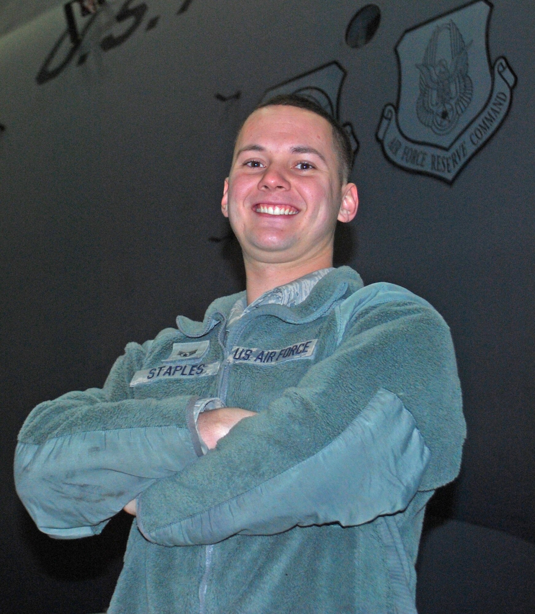 SrA. Nathan Staples, 439th Maintenance Squadron aerospace maintenance specialist, stands in front of a C-5 undergoing maintenance in the pull-through hangar. SrA. Staples recently saved the life of a local man after applying his self-aid buddy care training. 