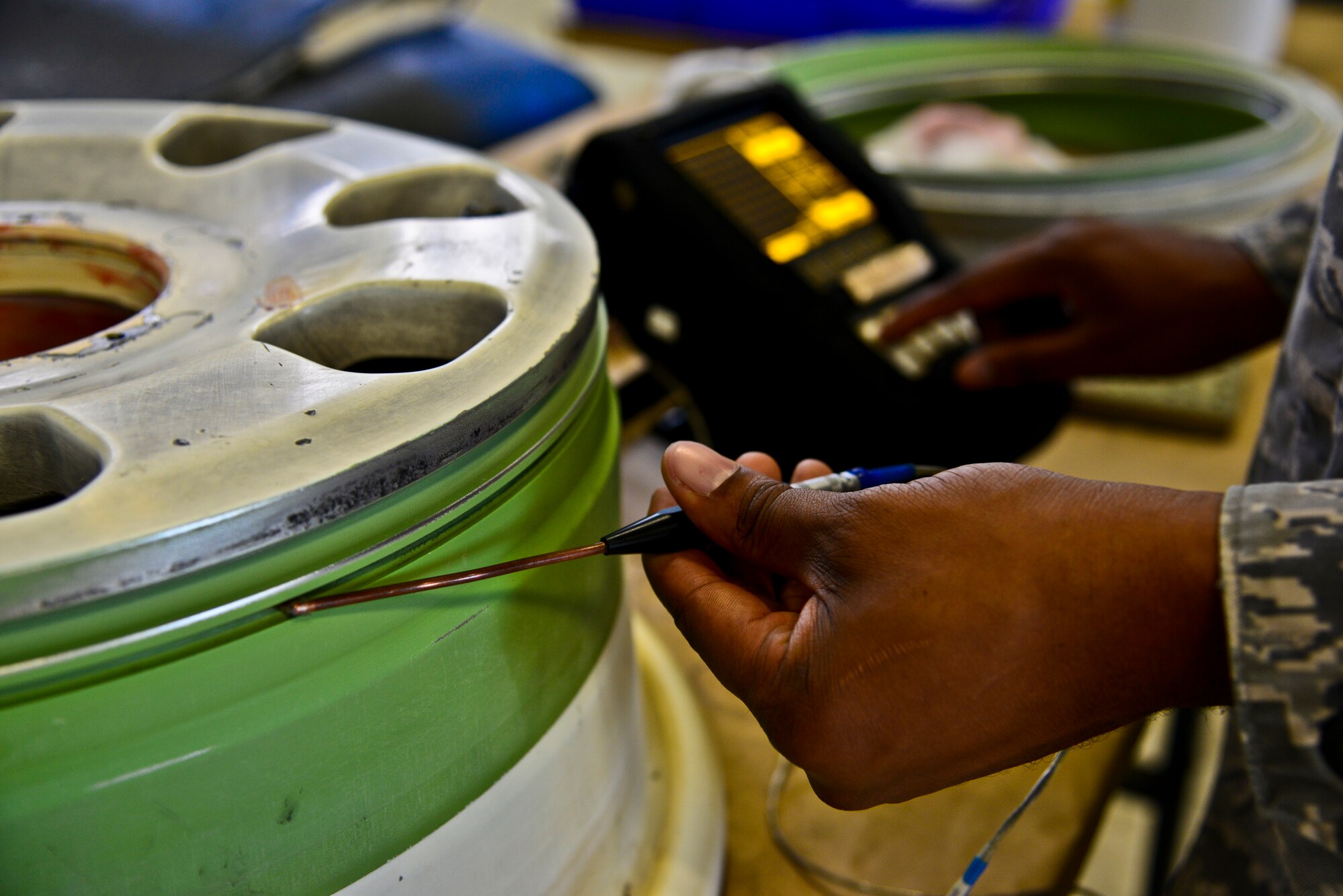 Staff Sgt. Dustin Harris, 6th Maintenance Squadron nondestructive inspection technician, inspects a main landing gear wheel hubcap assembly for a Gulfsteam G550 aircraft at MacDill Air Force Base, Fla., Nov. 26, 2013. Harris used a Nortec 2000D+ Eddy Current Flaw Detector to perform the test, which shows faults in the part on the display of the machine. (U.S. Air Force photo by Airman 1st Class Ned T. Johnston/Released)