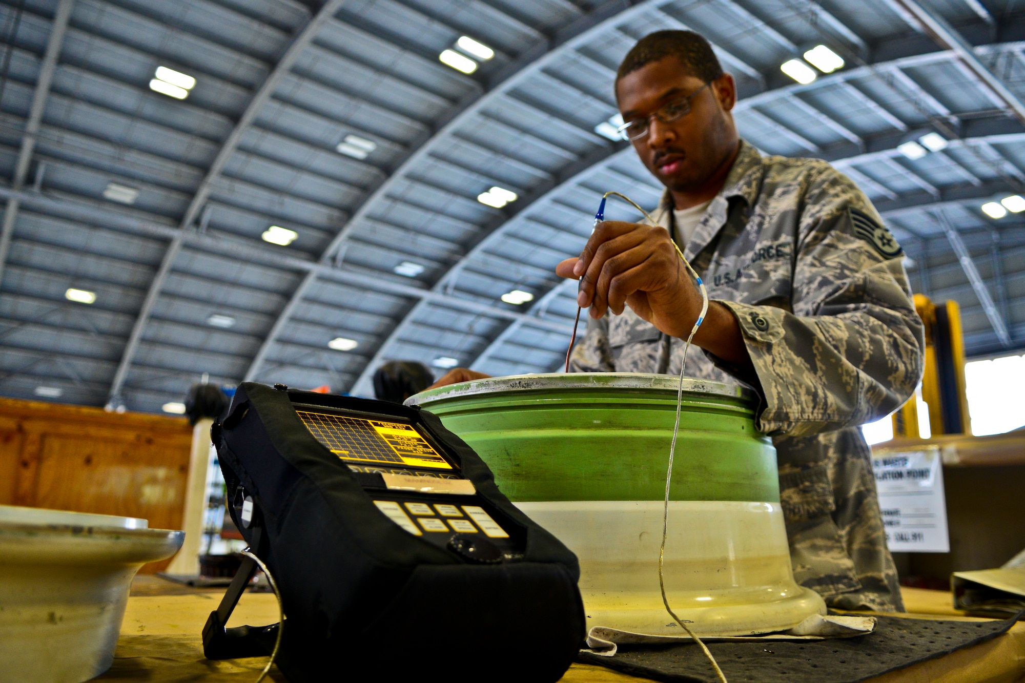 Staff Sgt. Dustin Harris, 6th Maintenance Squadron nondestructive inspection technician, uses a Nortec 2000D+ Eddy Current Flaw Detector to test for faults in a main landing gear wheel hubcap assembly for a Gulfsteam G550 aircraft at MacDill Air Force Base, Fla., Nov. 26, 2013. When the “Eddy” encounters an obstacle, such as a crack, the normal path of the current is changed, which displays on the machine. (U.S. Air Force photo by Airman 1st Class Ned T. Johnston/Released)