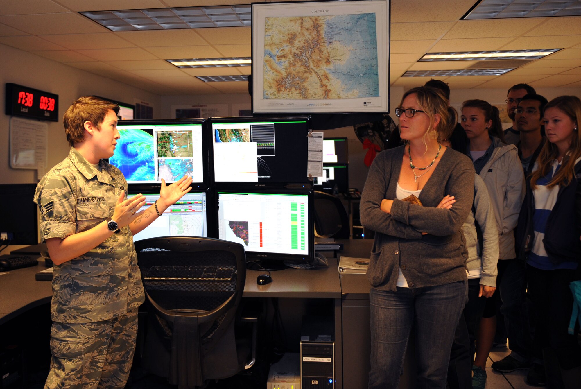 U.S. Air Force Senior Airman Amanda Dhane-Stevens, 25th Operational Weather Squadron shift supervisor, explains the different operations floor sections to students from the UA during a tour at the 25th OWS at Davis-Monthan Air Force Base, Ariz., Nov.22, 2013. The students were also given a brief on both the 25th OWS and the 612th Support Squadron and operational weather flight missions. (U.S. Air Force photo by Airman 1st Class Saphfire Cook/Released)
