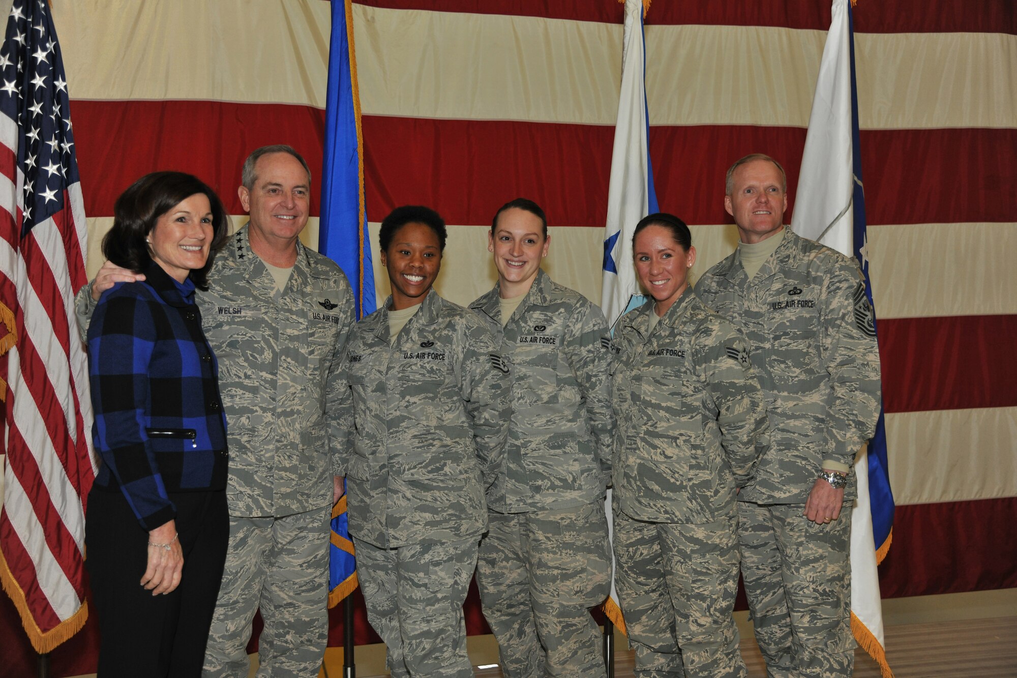 Chief of Staff of the Air Force Gen. Mark A. Welsh III, and his wife, Betty, and Chief Master Sgt. of the Air Force James A. Cody pose with Staff Sgt. Krytal Jones, Senior Airman Stephanie List and Senior Airman Courtney Moya during on Nov. 25, 2013, at Grand Forks Air Force Base, N.D. (U.S. Air Force photo/Senior Airman Xavier Navarro)