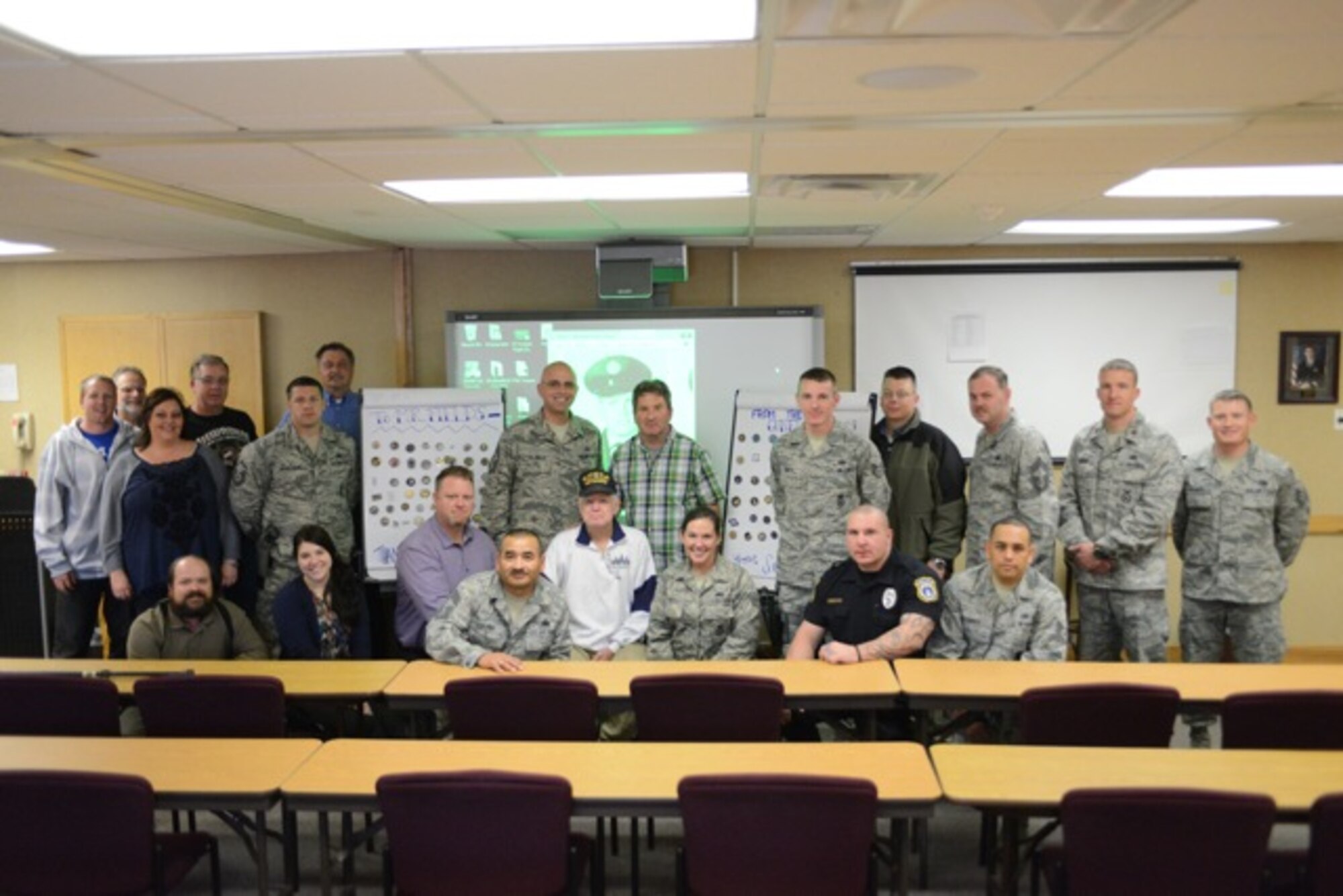 Members form the 366th Fighter Wing pose for a group photo at a re-coining event Nov 27, 2013, at Mountain Home Air Force Base, Idaho. With Thanksgiving a day away, Airmen came together to assist a fellow member of the Gunfighter family who was recently the victim of a bruglery. (U.S. Air Force photo by Senior Airman Benjamin Sutton/Released) 
