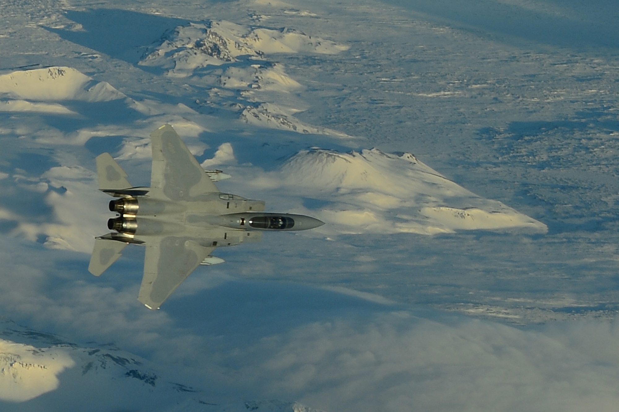 An F-15C Eagle, deployed from Royal Air Force Lakenheath, England performs a mock aerial interception while flying over Iceland Nov. 21, 2013. The 48th Air Expeditionary Group has been maintaining the North Atlantic Treaty Organization air surveillance and policing mission in Iceland since Oct. 28, 2013. (U.S. Air Force photo by Airman 1st Class Dana J. Butler/Released)