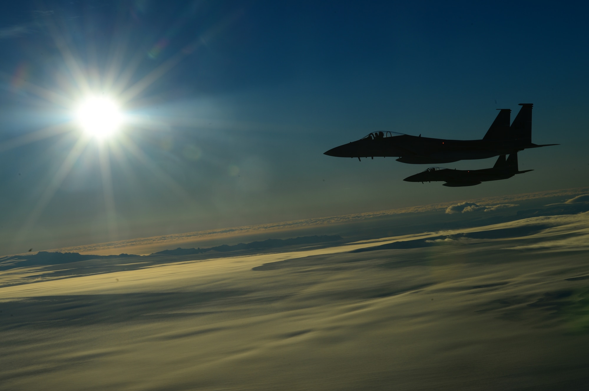 Two F-15C Eagles, deployed from Royal Air Force Lakenheath, England, perform a mock aerial interception on a KC-135 Stratotanker, deployed from RAF Mildenhall, England, while flying over Iceland Nov. 21, 2013. The 48th Air Expeditionary Group has been maintaining the North Atlantic Treaty Organization air surveillance and policing mission in Iceland since Oct. 28, 2013. (U.S. Air Force photo by Airman 1st Class Dana J. Butler/Released)