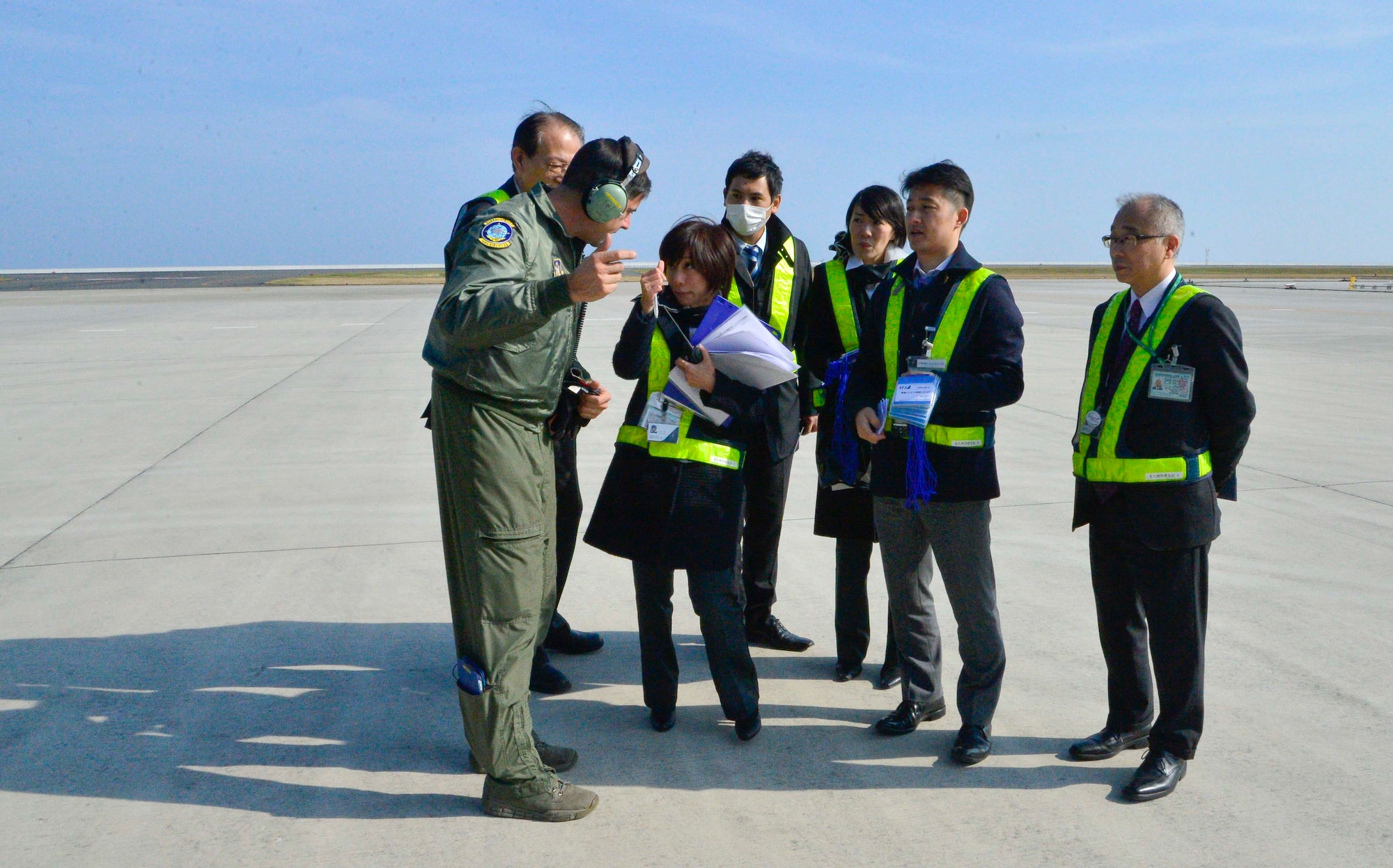 Air Force Reserve Master Sgt. Kevin Calhoun, 709th Airlift Squadron flight engineer, talks to Japanese officials following the delivery of the Global Precipitation Measurement Satellite Nov. 24, 2013, to Kitakyushu Airport in Japan.  Calhoun and the aircrew from the 709th Airlift Squadron safely delivered the satellite, which will be vital in better predicting storms patterns throughout North America. (U.S. Air Force photo/Tech. Sgt. Jeremy Larlee)