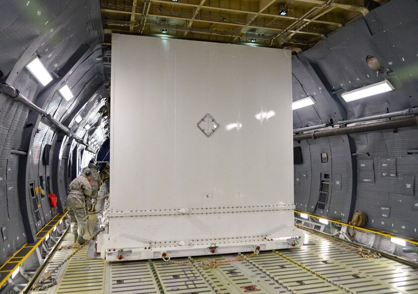 A Global Precipitation Measurement Satellite is placed into the cargo compartment of a C-5M Super Galaxy Nov. 20, 2013, at Joint Base Andrews, Md. The satellite and its container, which weighed approximately 57,000 pounds, were slowly and carefully winched into the aircraft. (U.S. Air Force photo/Tech. Sgt. Jeremy Larlee)