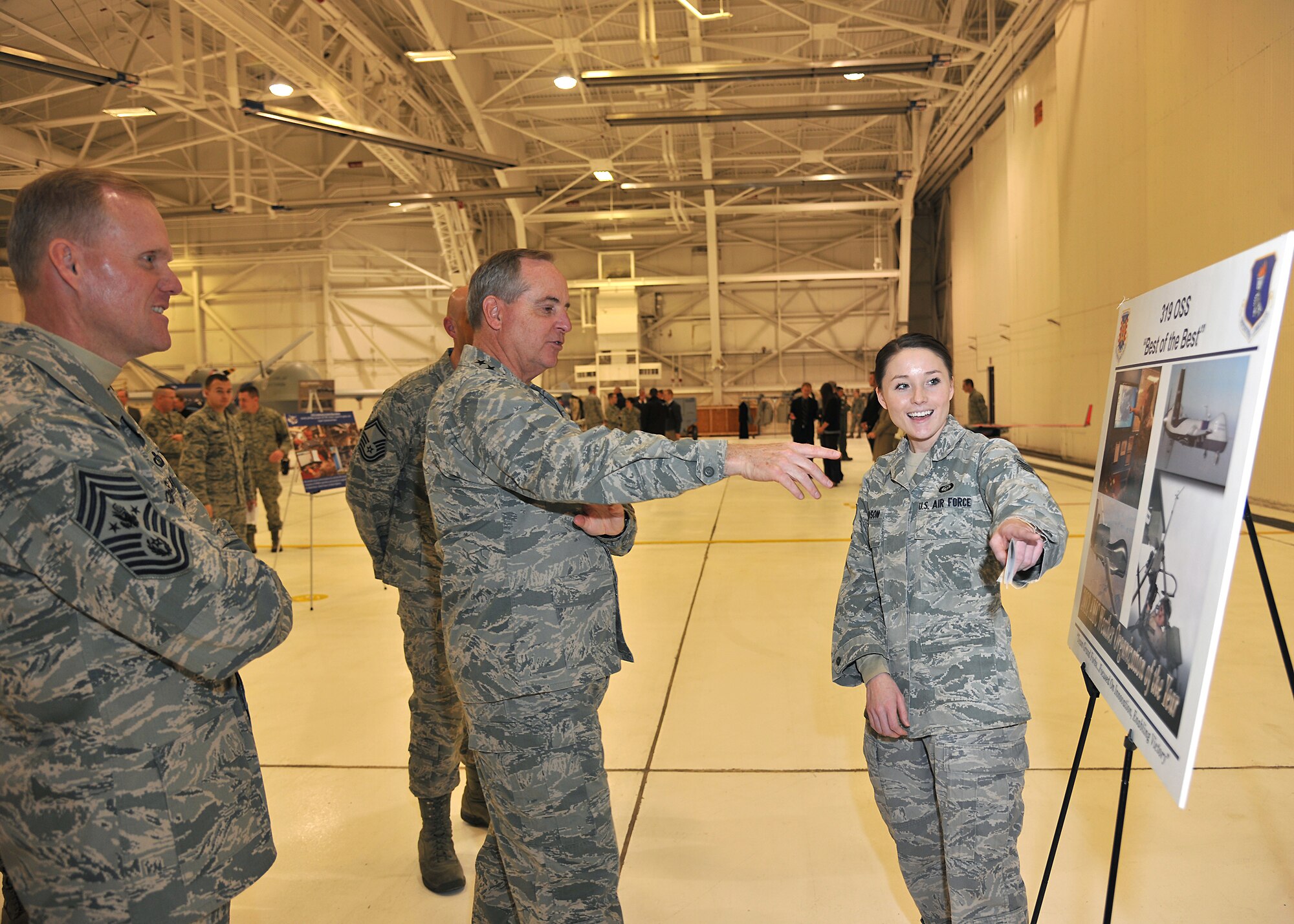 (Right) Staff Sgt. Amanda Davidson, 319th Operations Support Squadron weather forecaster, briefs Air Force Chief of Staff Gen. Mark A. Welsh III, and Chief Master Sergeant of the Air Force James A. Cody, Nov. 26, 2013 on Grand Forks Air Force Base, N.D. The briefing on how the 319th OSS provides for the mission was part of the second day of the senior Air Force leadership’s official visit to the base. (U.S. Air Force photo/Senior Airman Xavier Navarro)