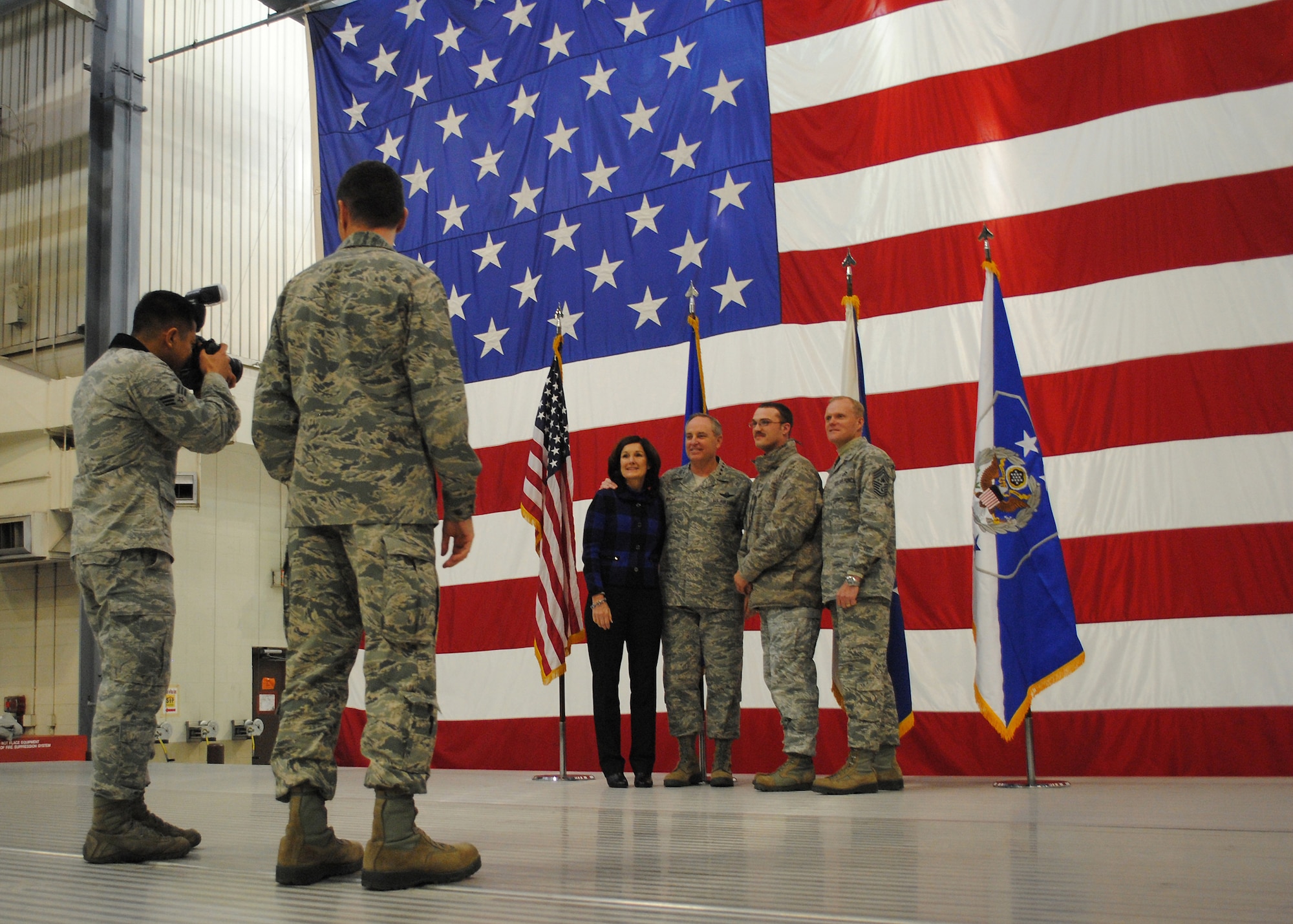 Senior Airman Xavier Navarro, of the 319th Air Base Wing Public Affairs office, takes a photo of a Warrior of the North meeting Air Force Chief of Staff Gen. Mark A. Welsh III, his wife, Betty, and Chief Master Sgt. of the Air Force James A. Cody on Nov. 25, 2013, at Grand Forks Air Force Base, N.D. (U.S. Air Force photo/Staff Sgt. Luis Loza Gutierrez) 