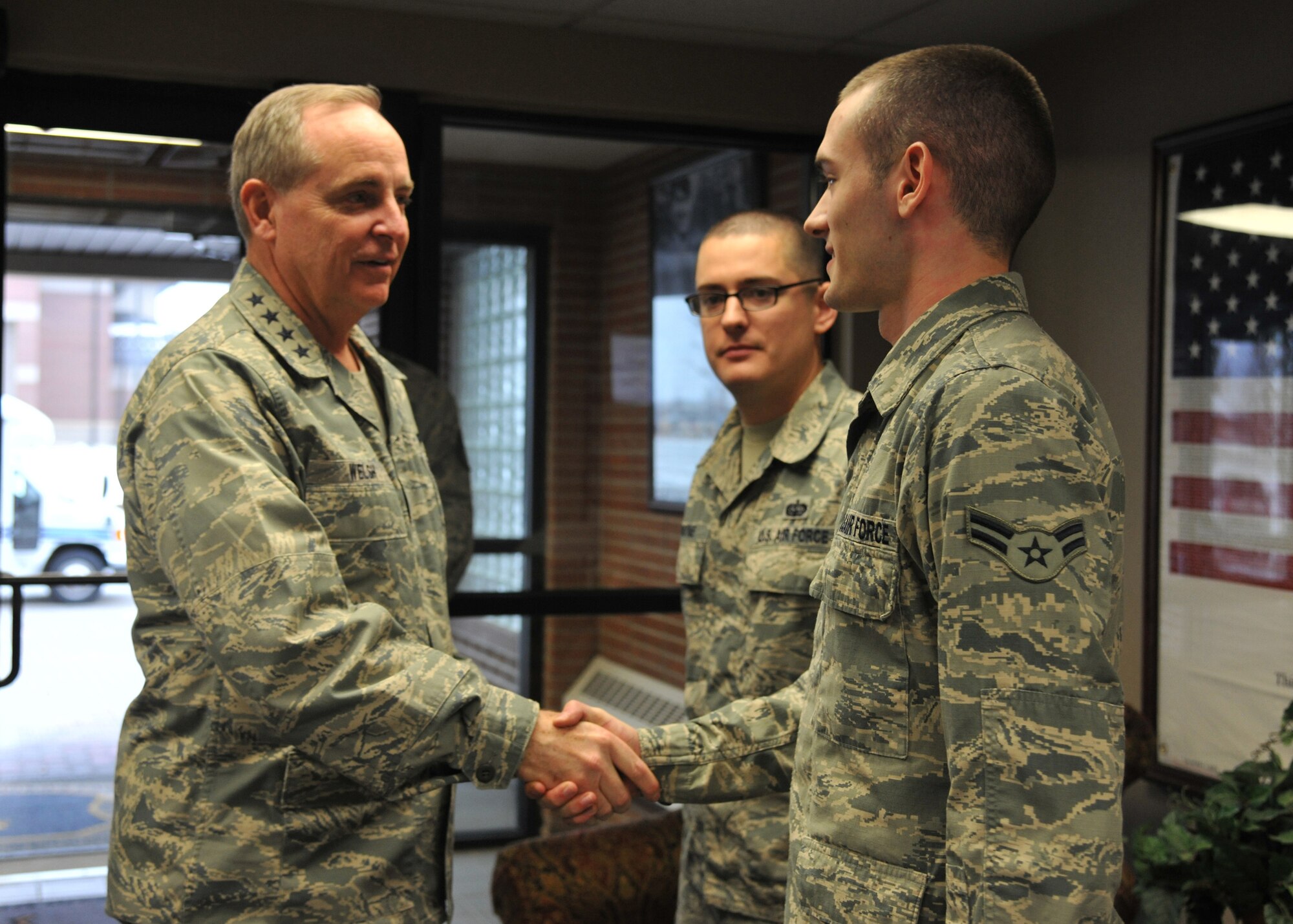 Chief of Staff of the Air Force Gen. Mark A. Welsh III shakes hands with A1C Bart Mistrot Jr. while Mistrot’s supervisor, SSgt. Jody Payne, looks on Nov. 25, 2013, at Grand Forks Air Force Base, N.D. Welsh, his wife, Betty, and Chief Master Sgt. of the Air Force James A. Cody visited the Airmen of the base Nov. 25 and 26, 2013. (U.S. Air Force photo/Senior Airman Xavier Navarro) 